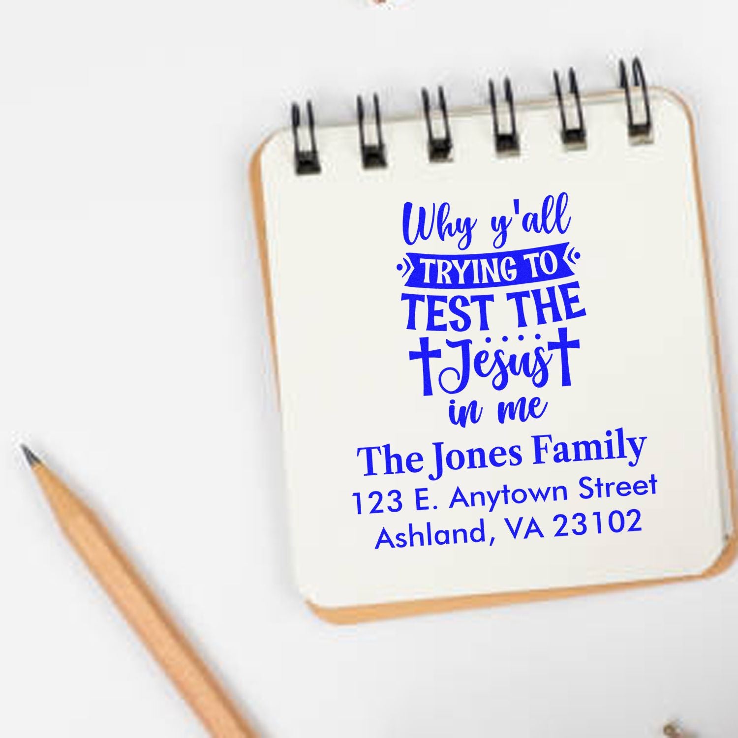 Custom rubber stamp with Christian quote and return address for The Jones Family in a notebook mockup, ideal for stationery.