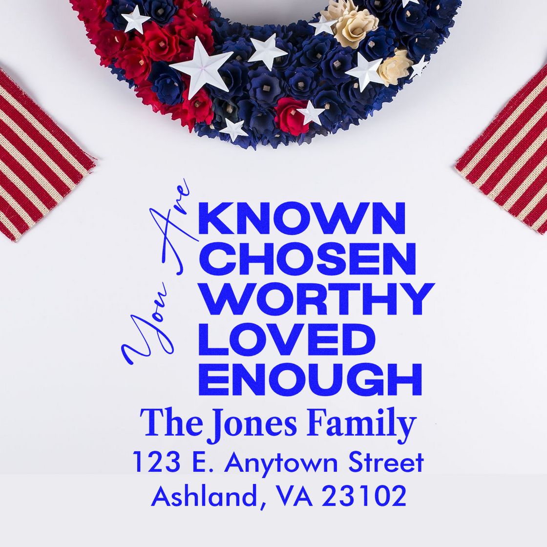 Personalized rubber stamp mockup with family name, return address, and inspirational quote in patriotic red, white and blue design.