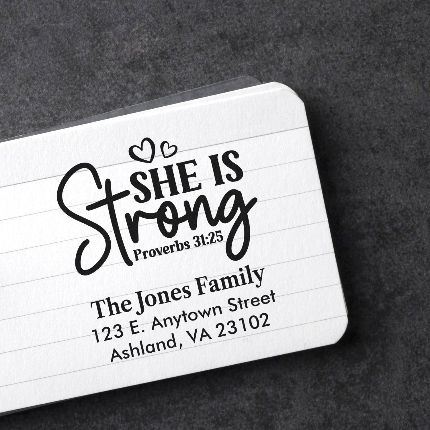 Custom rubber stamp with Proverbs 31:25 She is Strong and personalized family return address for faith-based stationery.