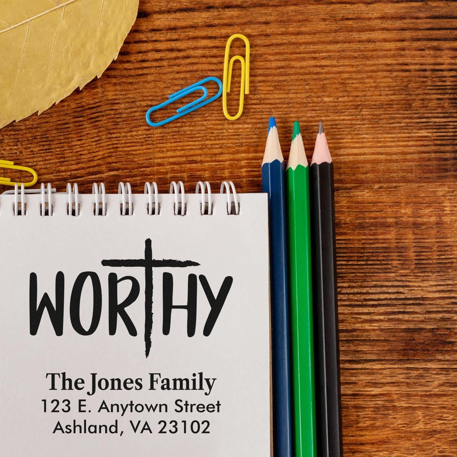 Custom family address rubber stamp with WORTHY design for personalized stationery and envelope labeling.