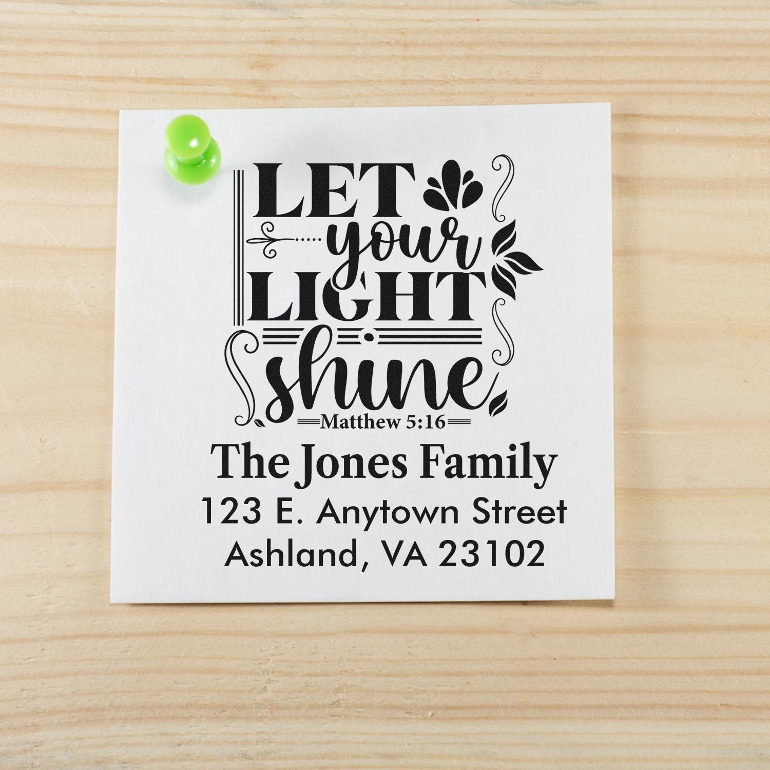 Custom rubber stamp with Let Your Light Shine Bible verse, family name, and return address for personalized mailing.