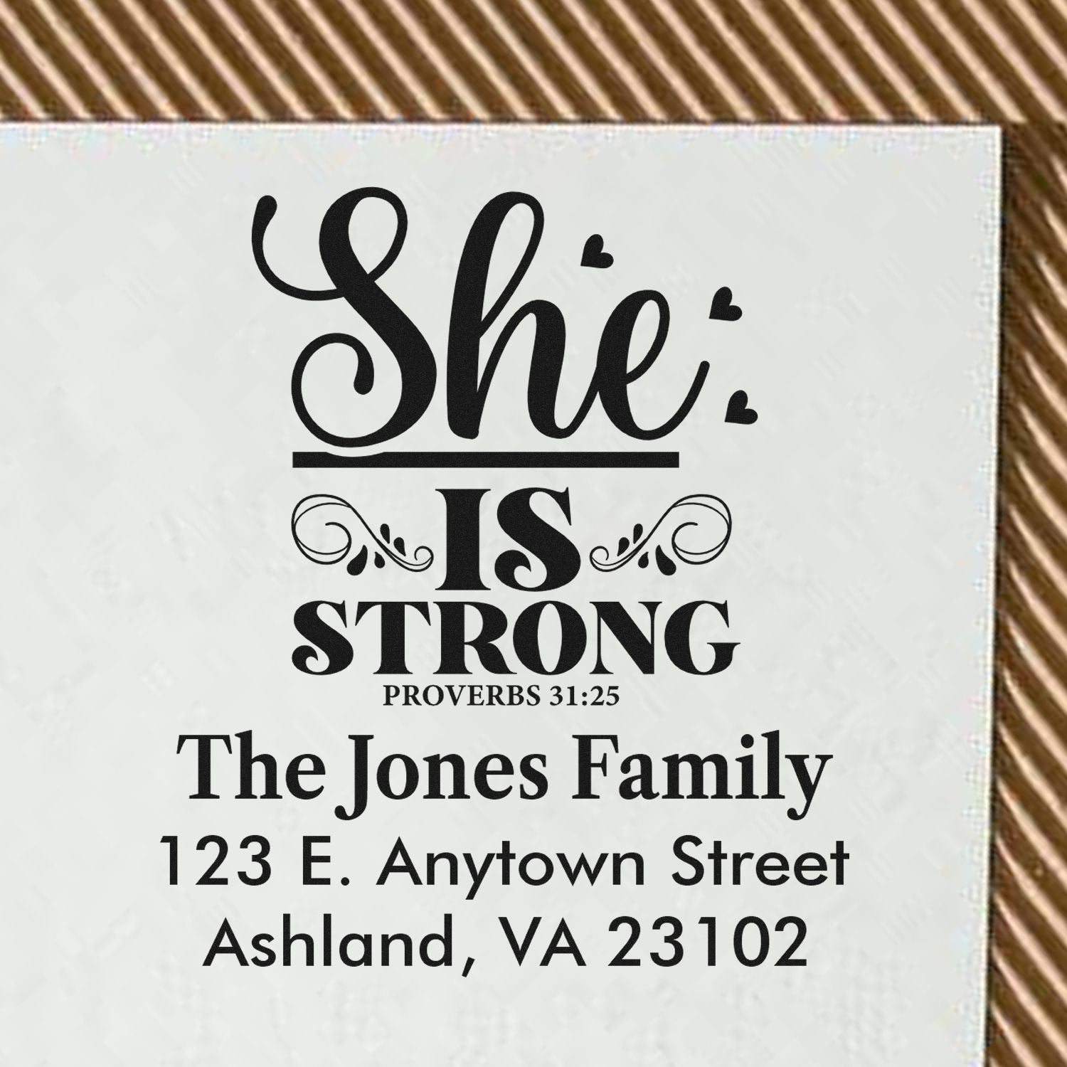 Custom Christian rubber stamp with She Is Strong Proverbs 31:25, personalized for The Jones Family and address.