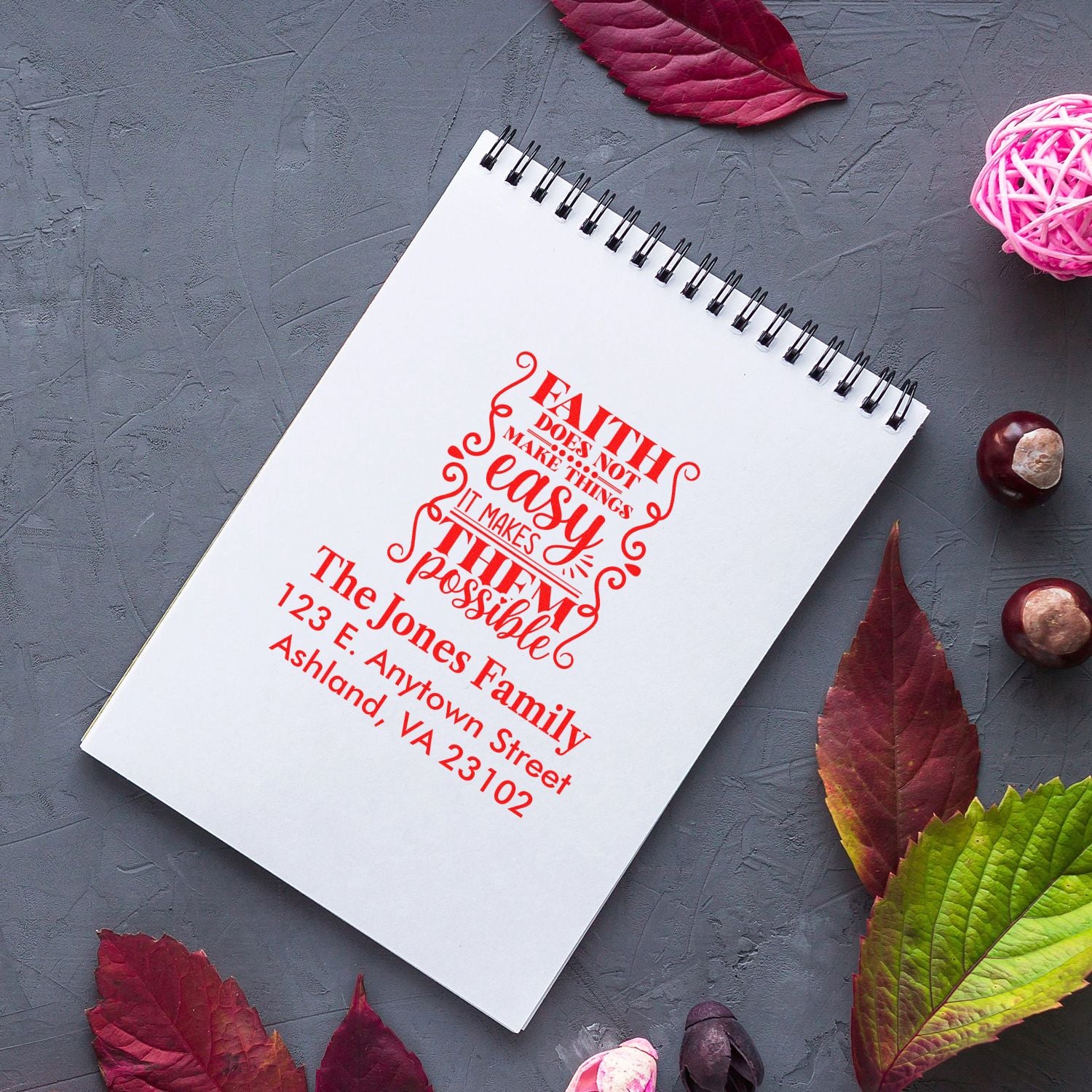 Custom rubber stamp with faith quote and return address on notebook, ideal for personalized stationery and small business branding.