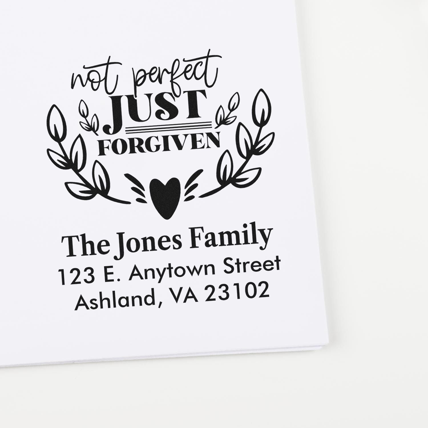 Custom return address rubber stamp with Not Perfect, Just Forgiven design, family name, and address.