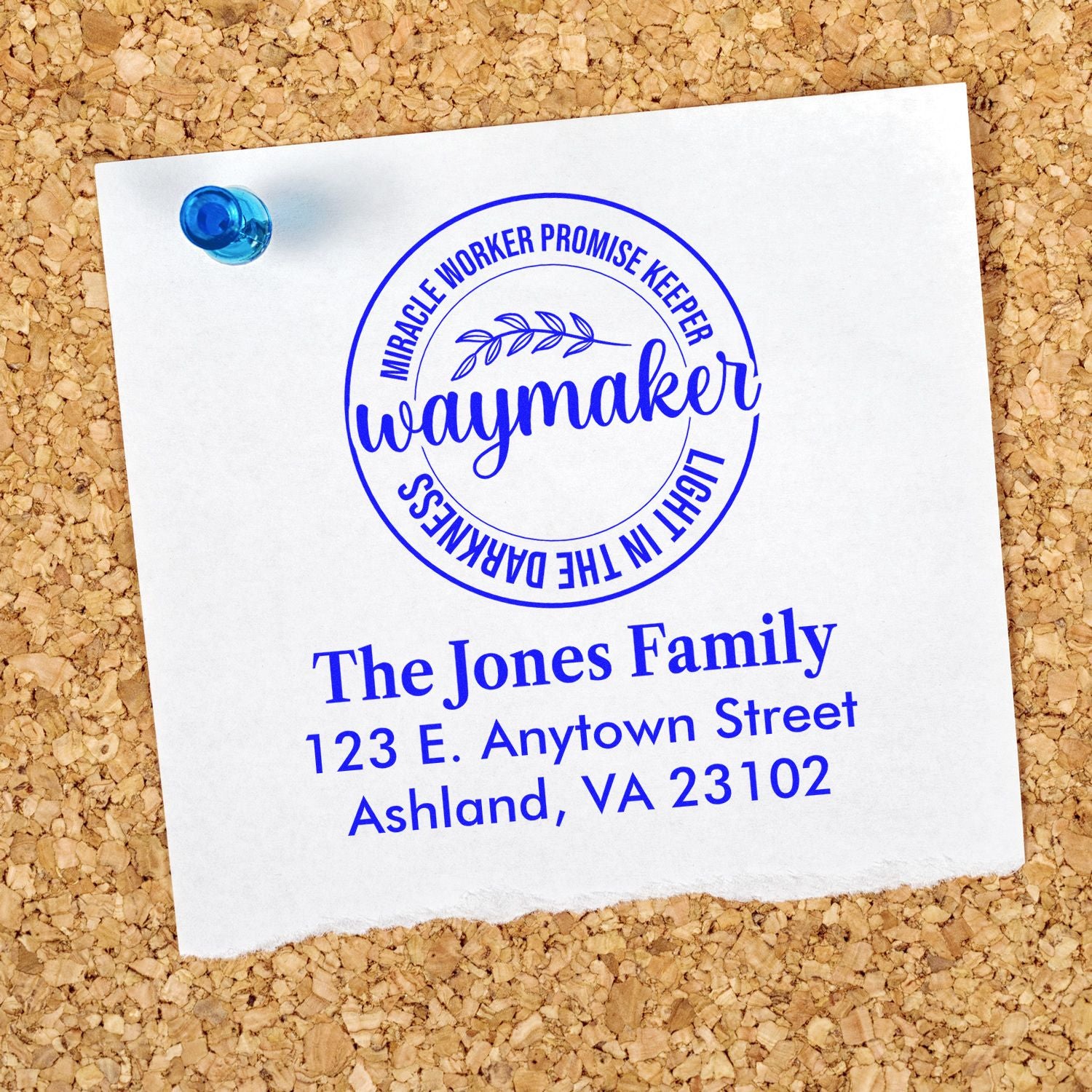Personalized Waymaker family return address rubber stamp with faith design on paper pinned to corkboard.