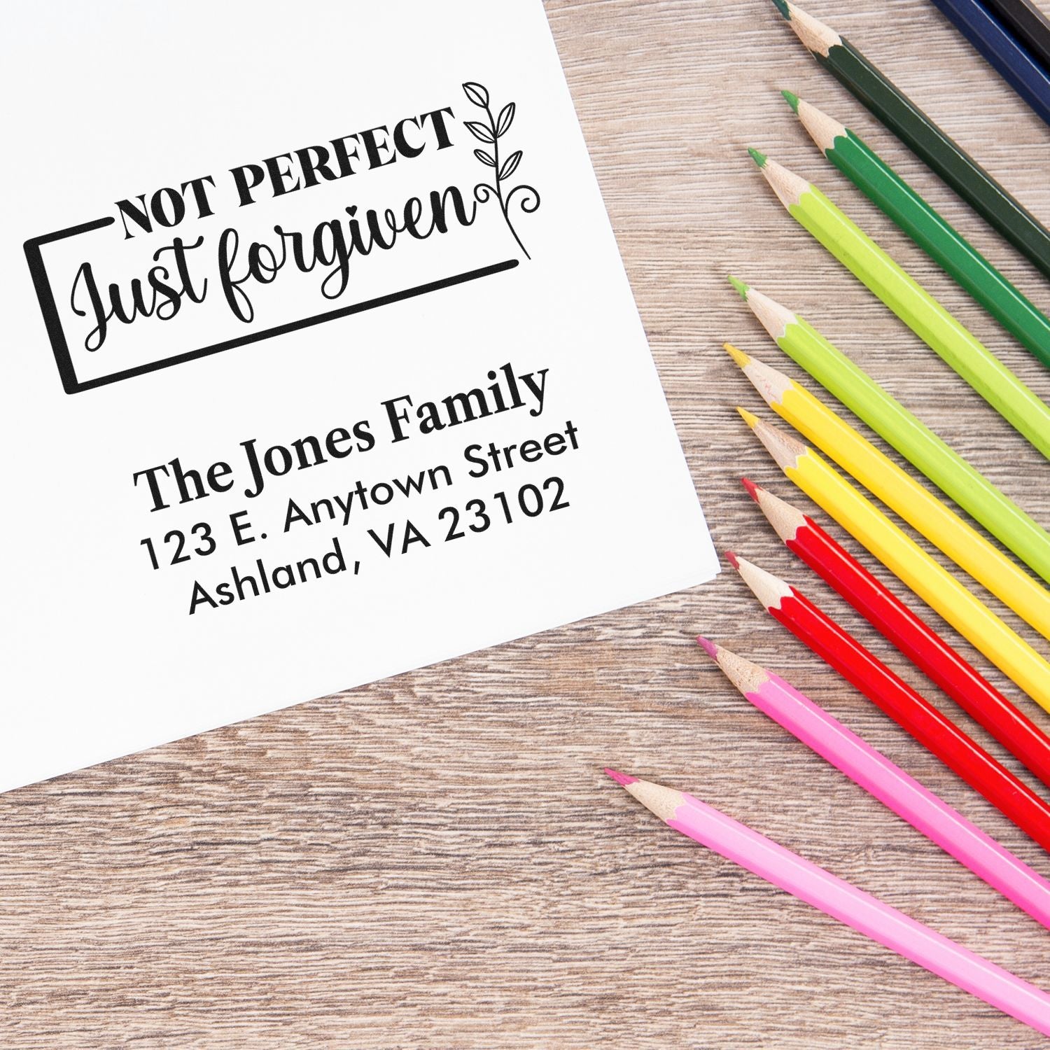 Personalized rubber stamp design with Not Perfect Just Forgiven quote and family return address for custom stationery.