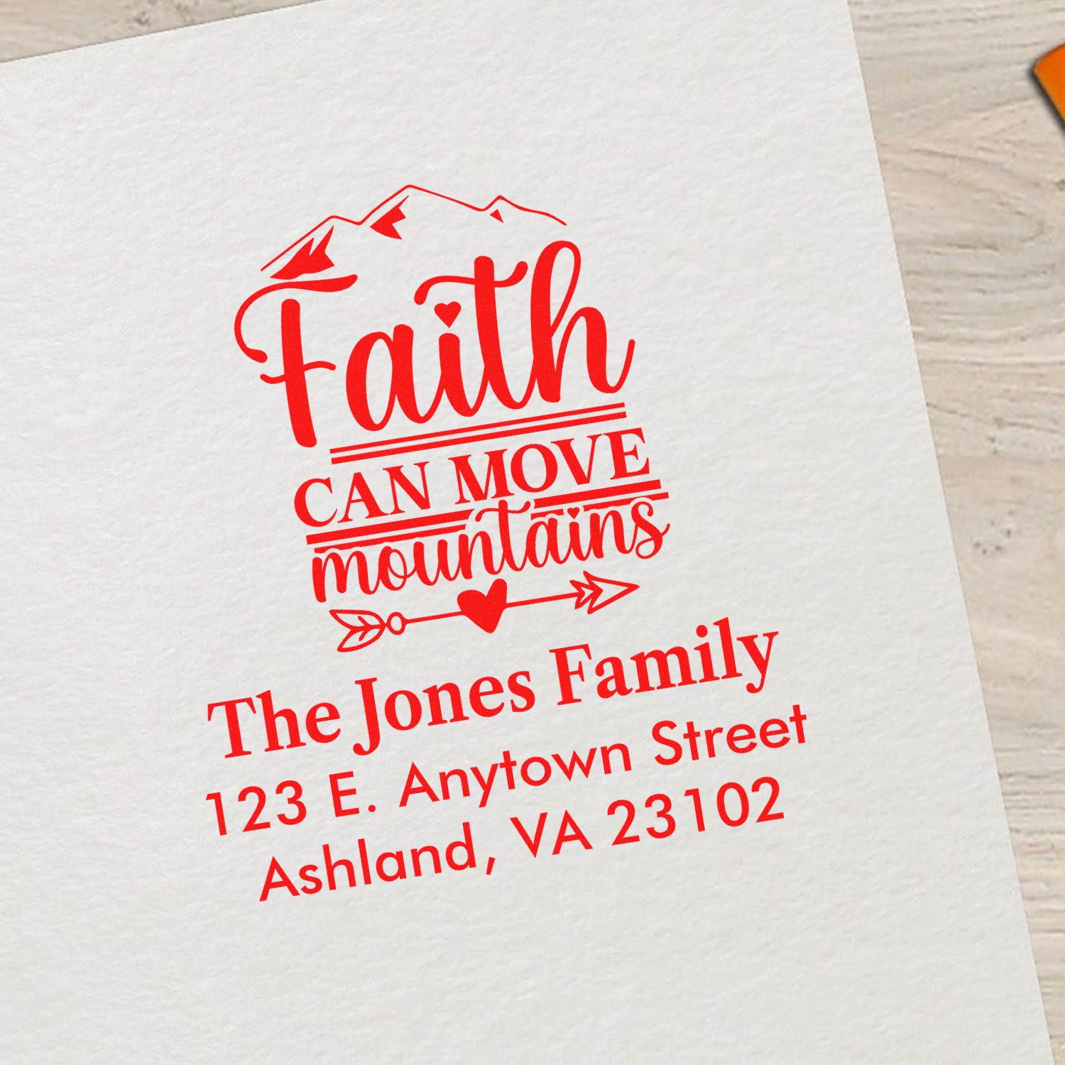 Custom rubber stamp design with Faith Can Move Mountains quote and personalized family return address.