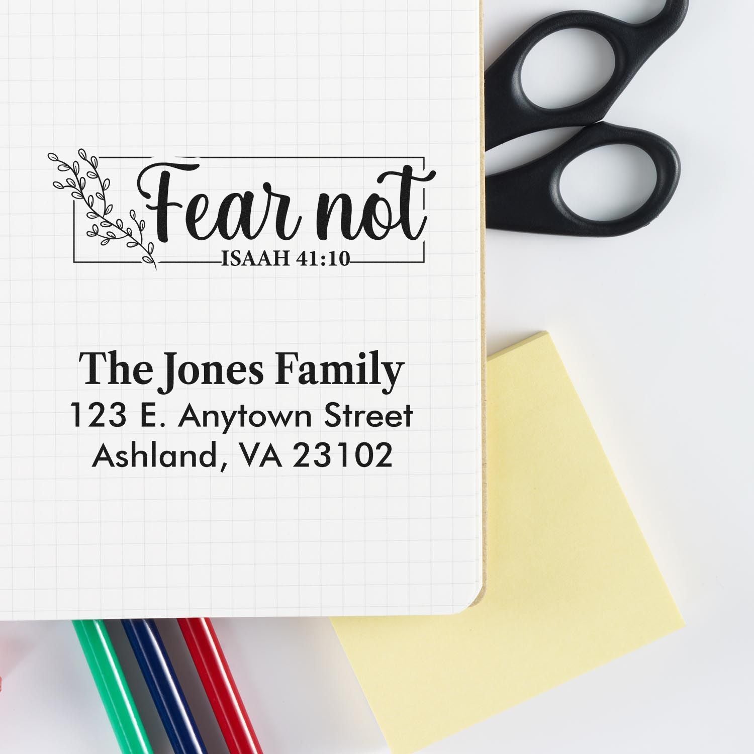 Custom rubber stamp mockup showing a faith-based Fear Not Bible verse stamp and personalized family address stamp.