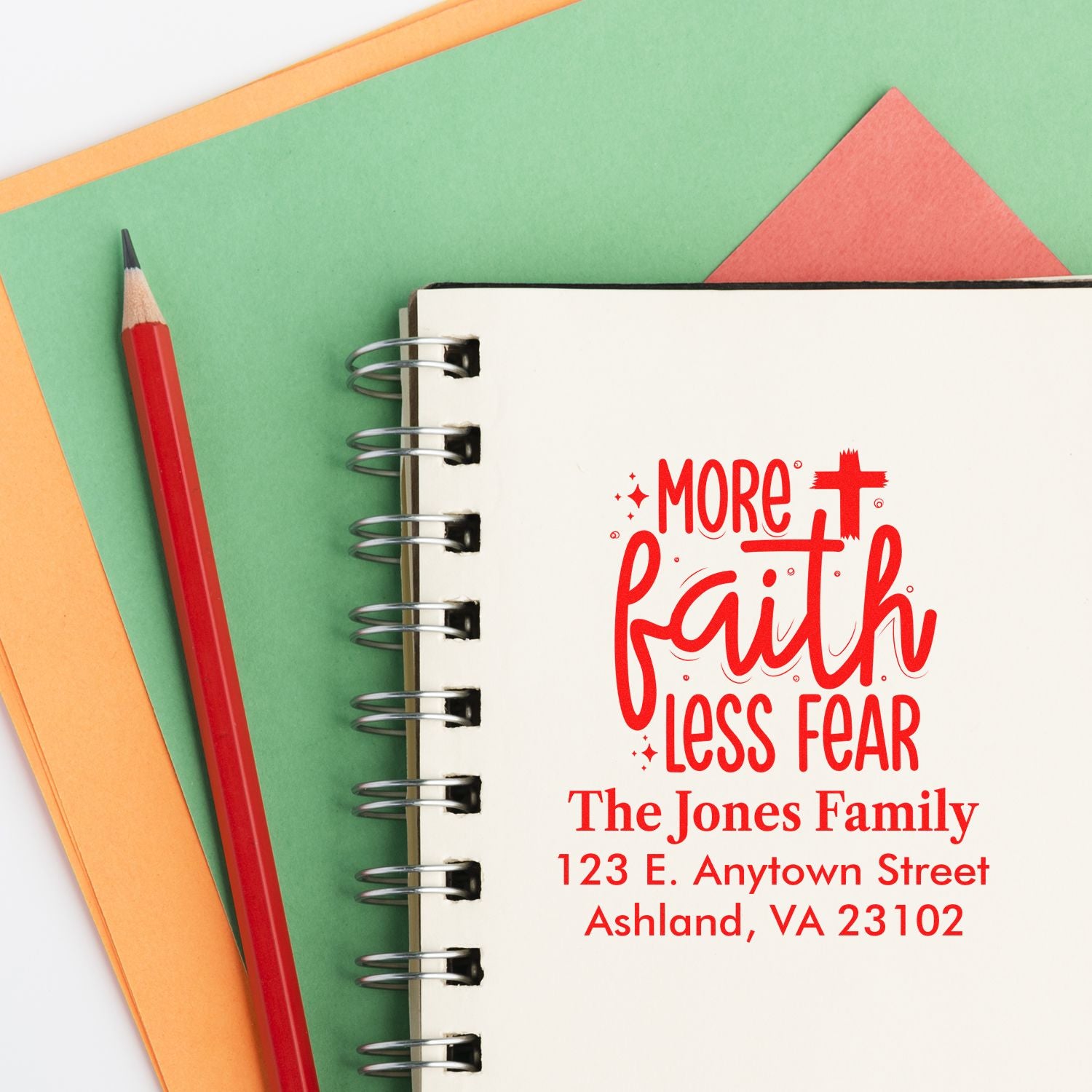Custom rubber stamp design with More Faith Less Fear slogan and family return address for personalized stationery.