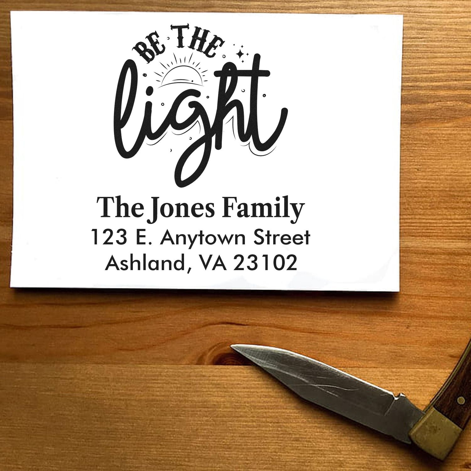 Custom rubber stamp with Be the Light design and family return address for personalized mail and packaging.
