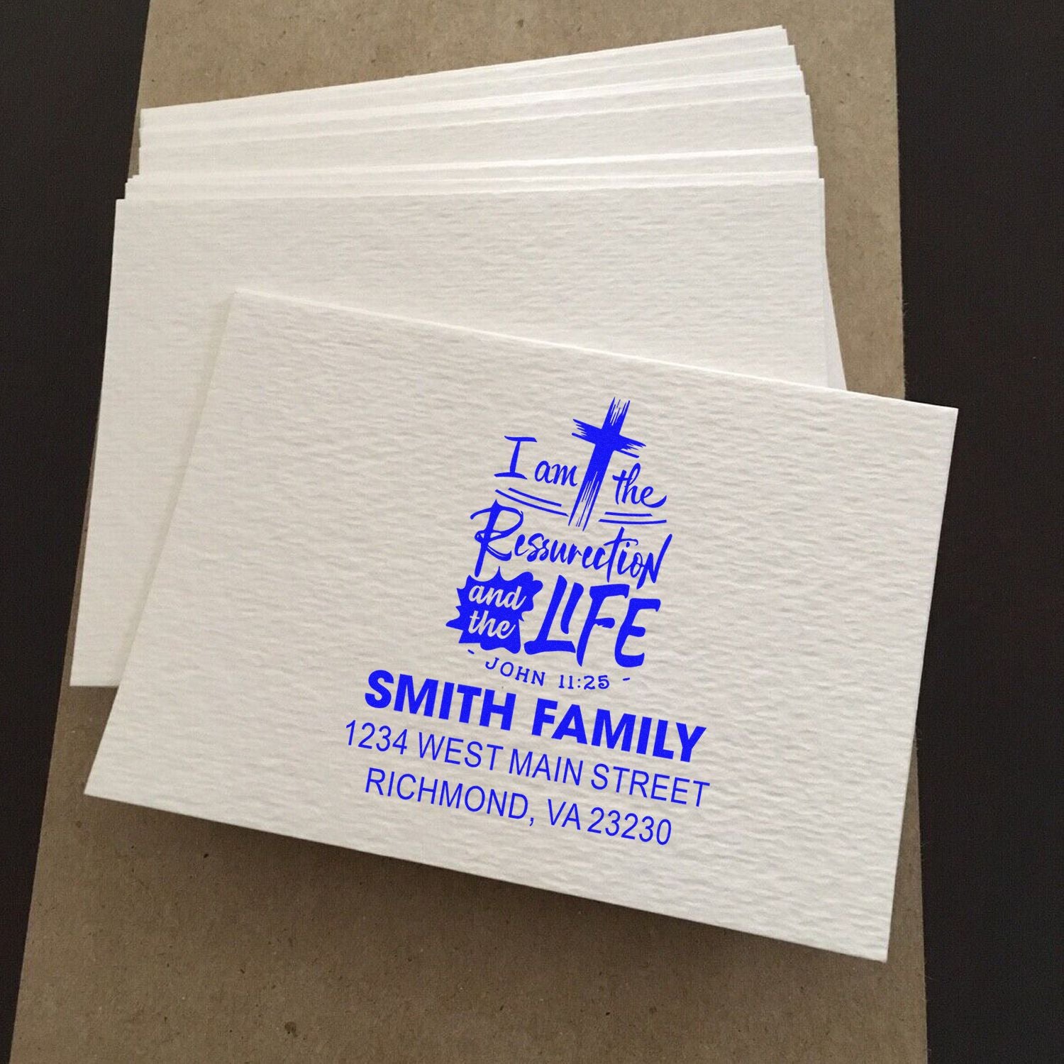 Personalized religious rubber stamp with cross, John 11:25, Smith family name, and return address imprint.