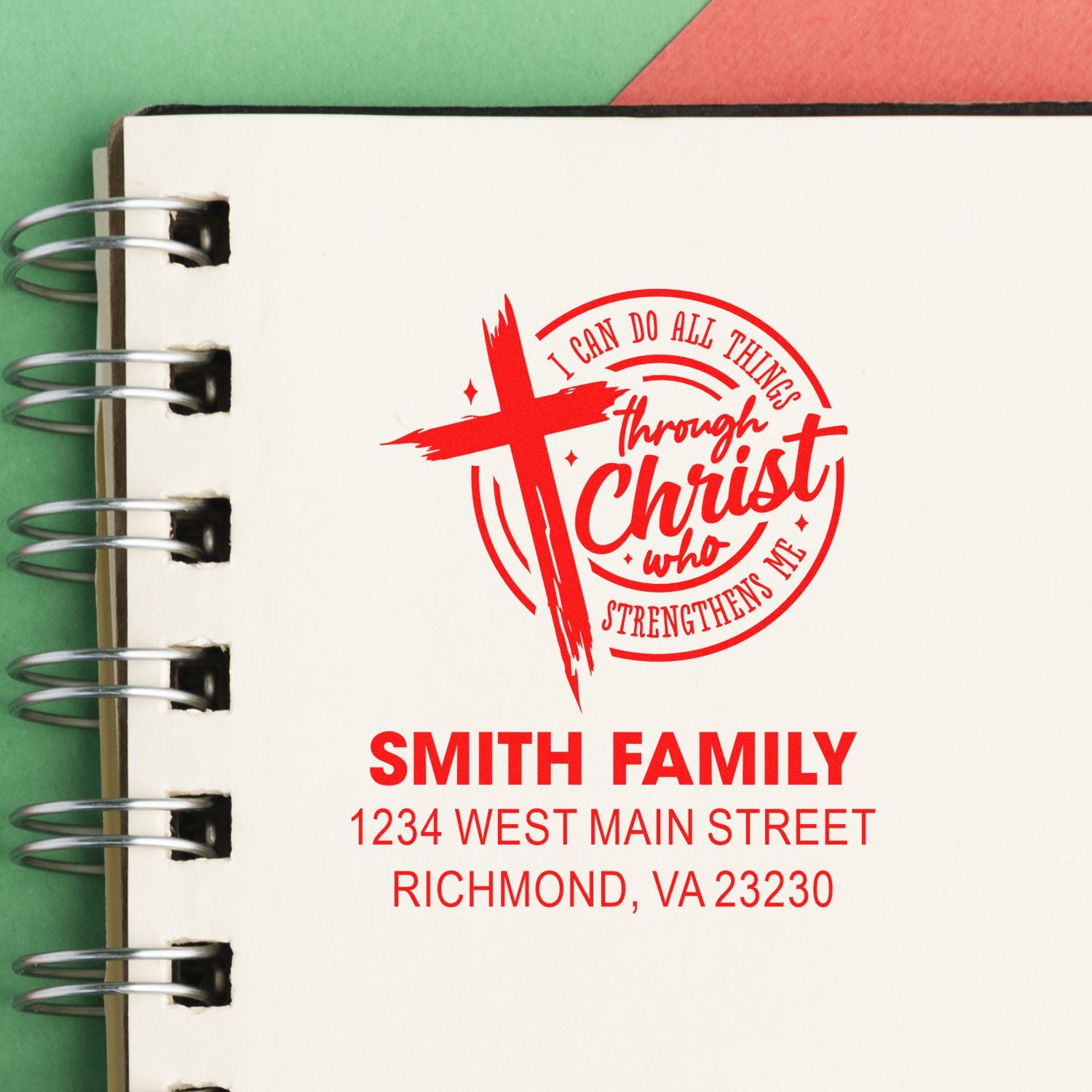 Personalized Christian address rubber stamp with cross and Bible verse for Smith family on a notebook page.