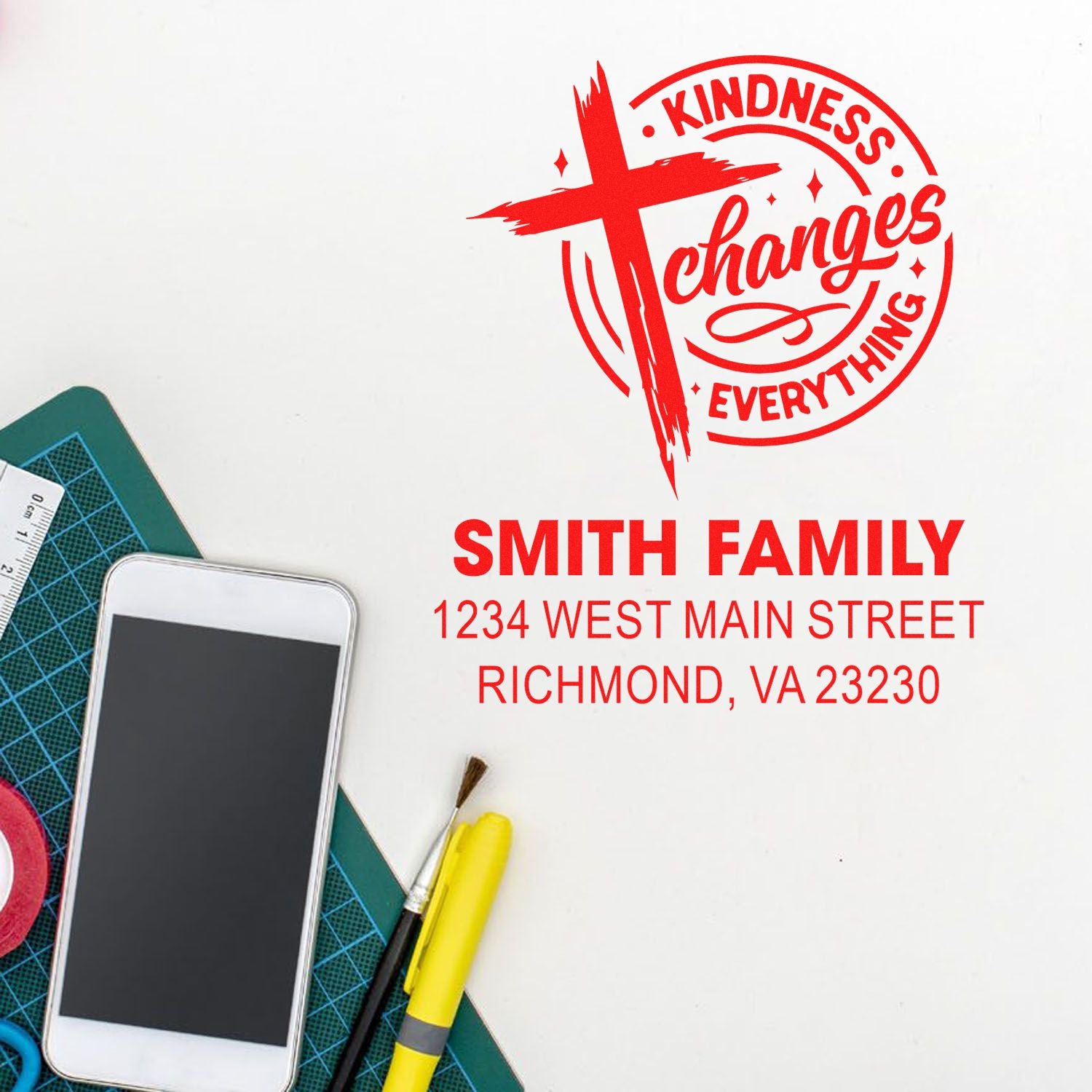 Custom address rubber stamp with Kindness Changes Everything cross logo for Smith Family, 1234 West Main Street, Richmond, VA.