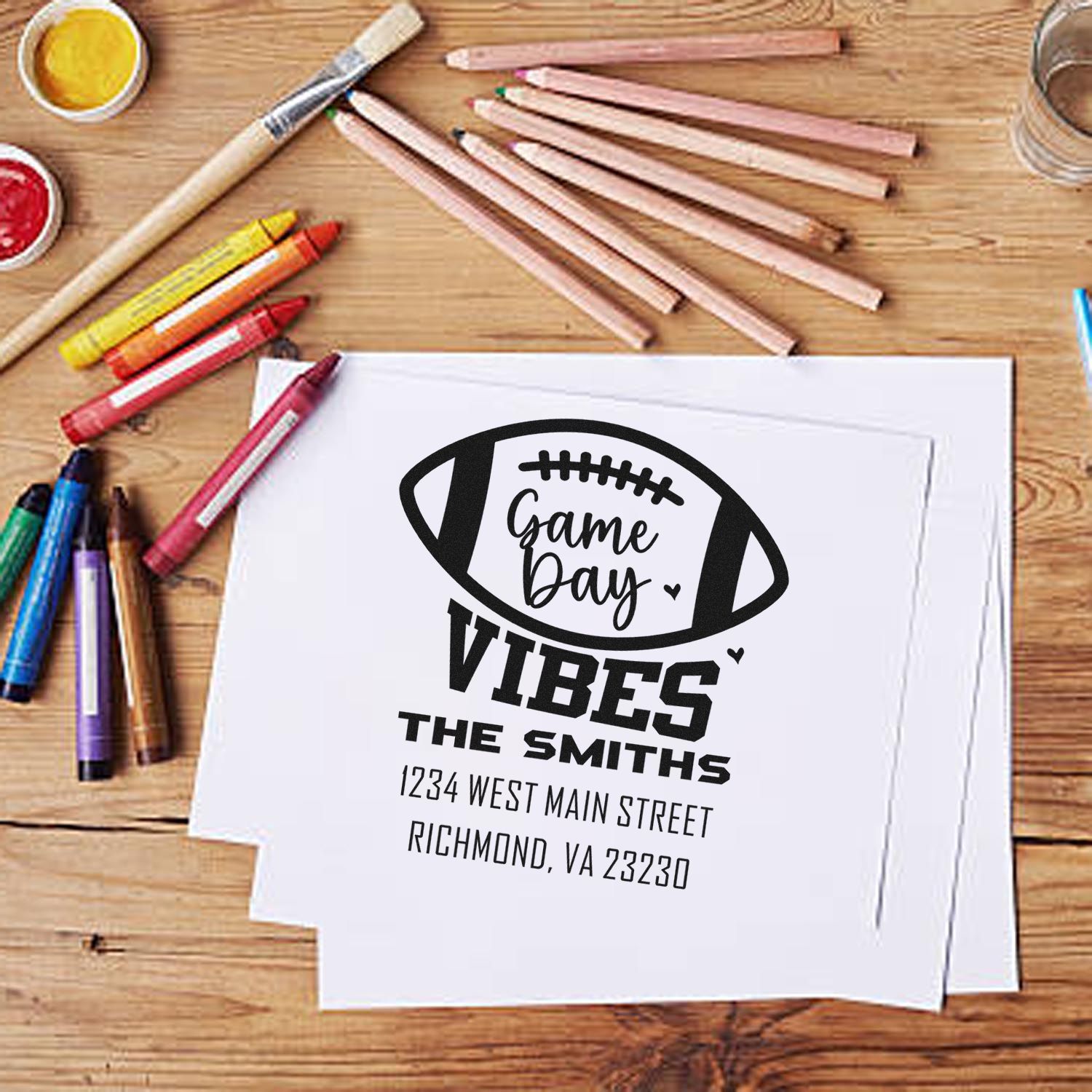 Custom football game day rubber stamp with family name and address, perfect for personalized sports-themed stationery.