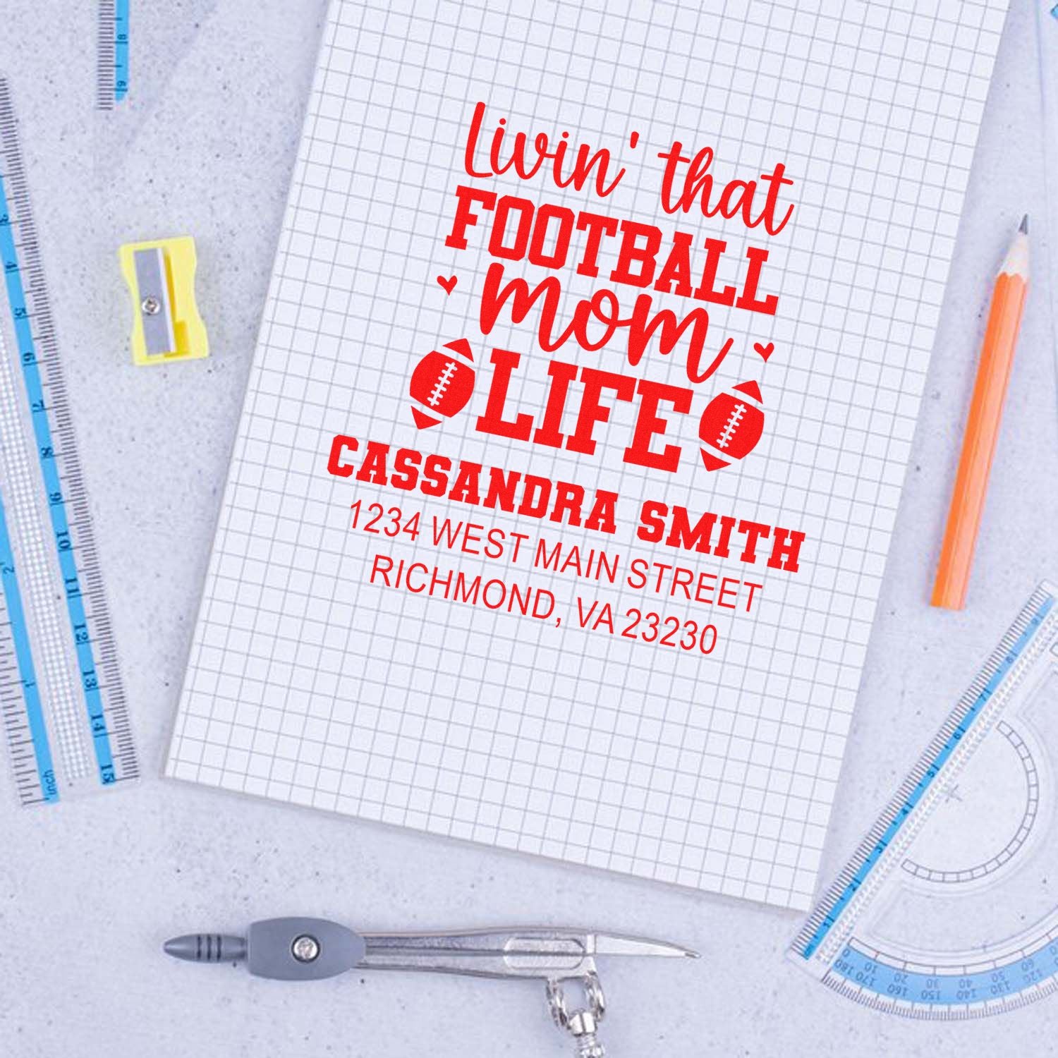 Custom football mom rubber stamp design with personalized name and address, shown on graph paper.