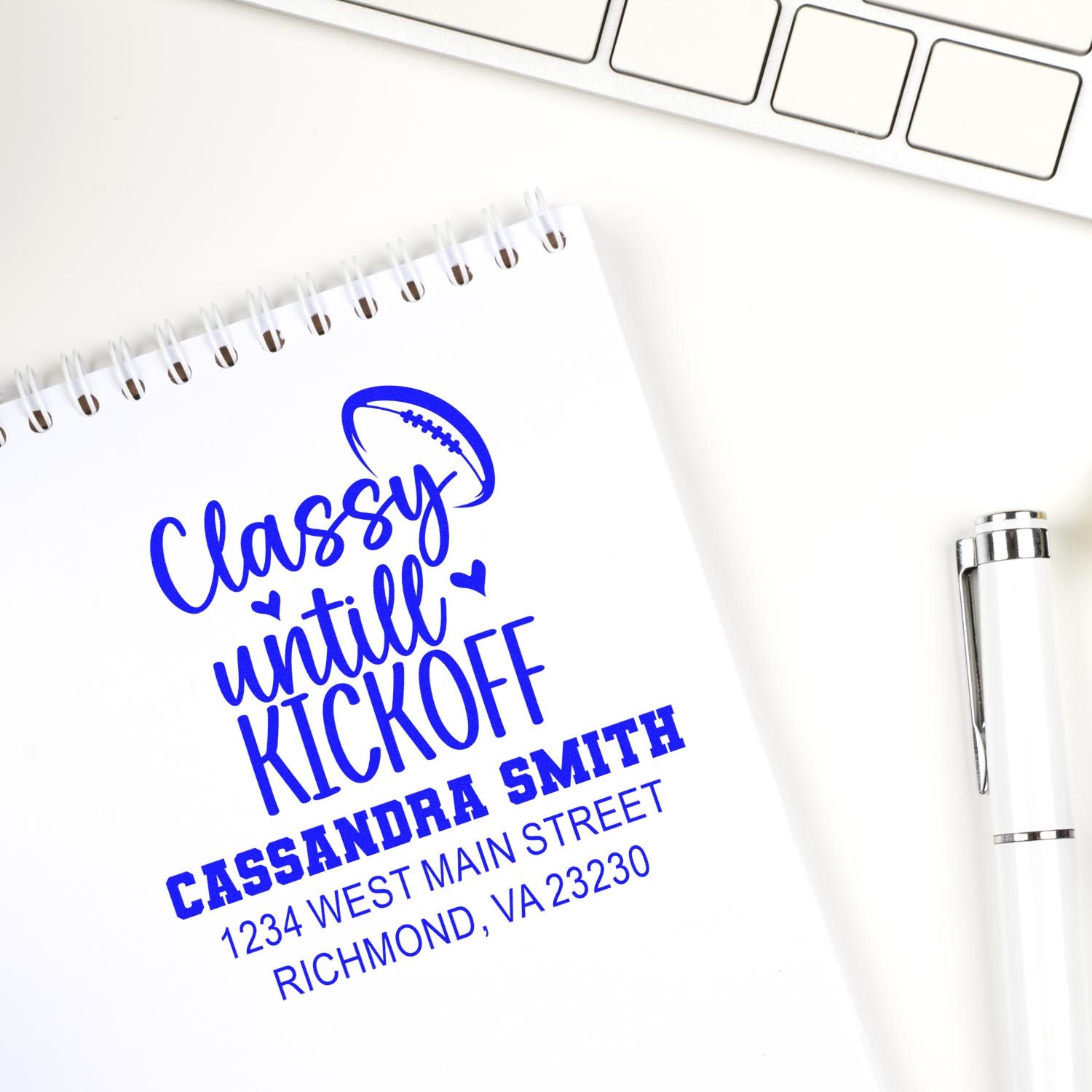 Custom rubber stamp impression on notebook, featuring Classy until Kickoff football design with name and address.