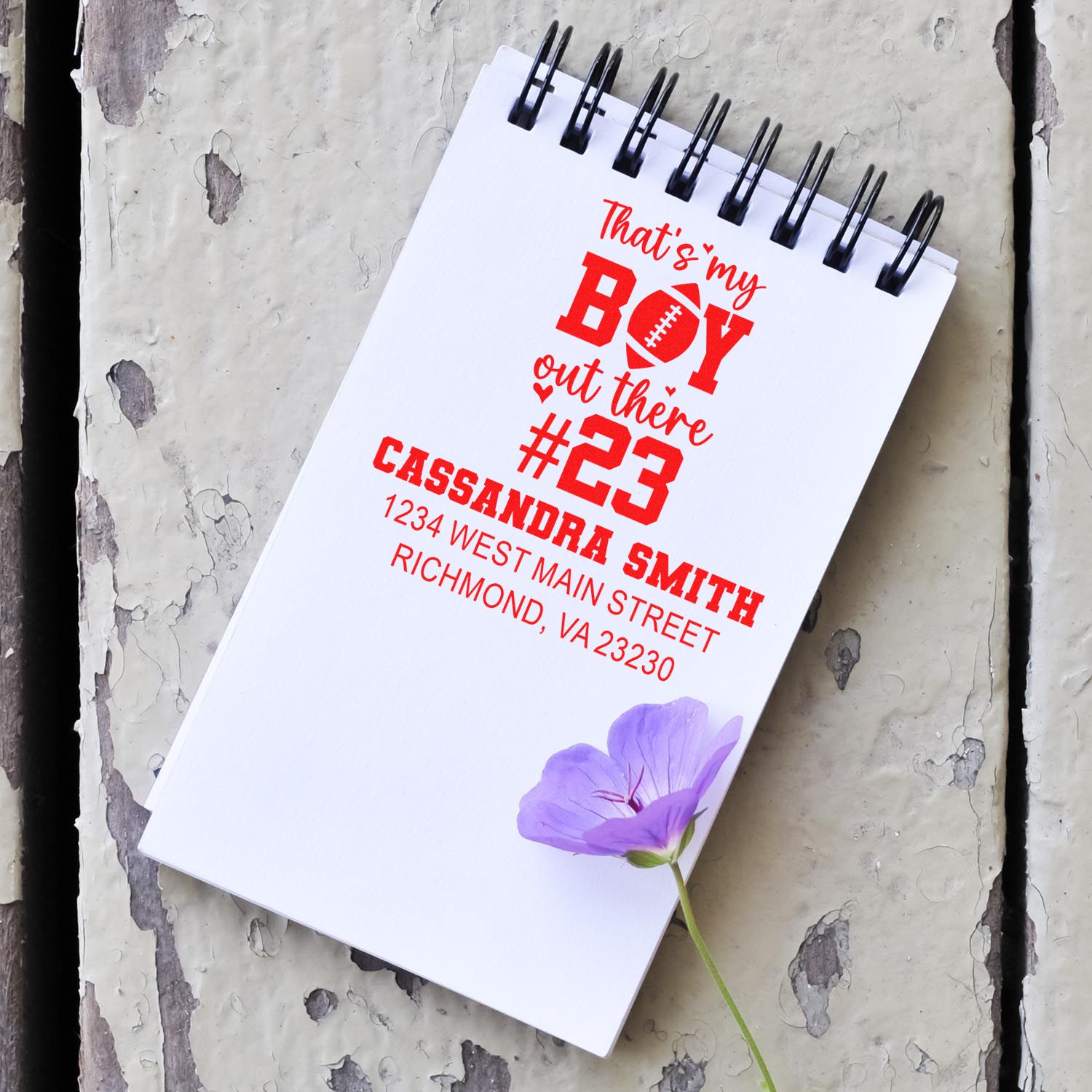 Custom football rubber stamp design with personalized boy #23, name, and return address for sports-themed stationery.