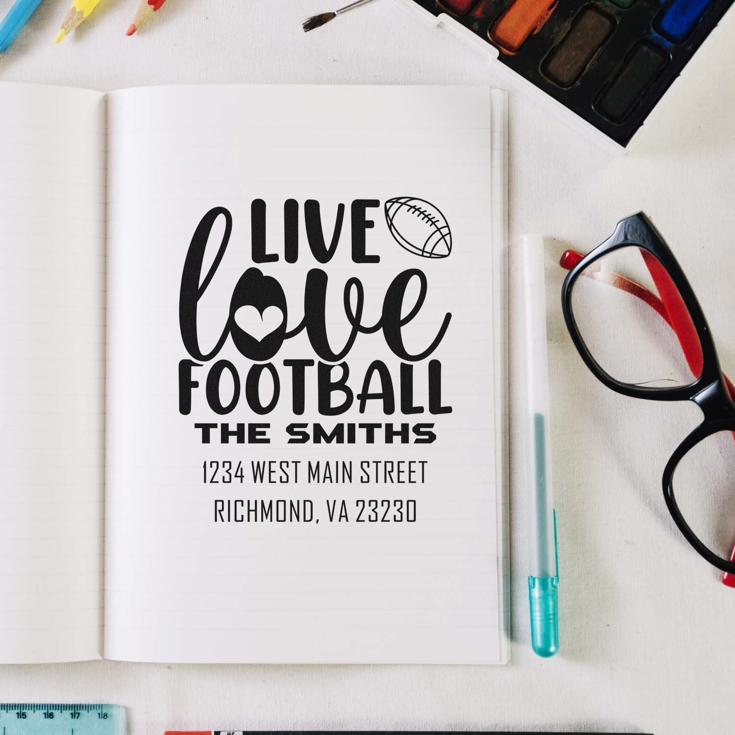 Custom football address stamp with Live Love Football, family name, and address for personalized stationery.