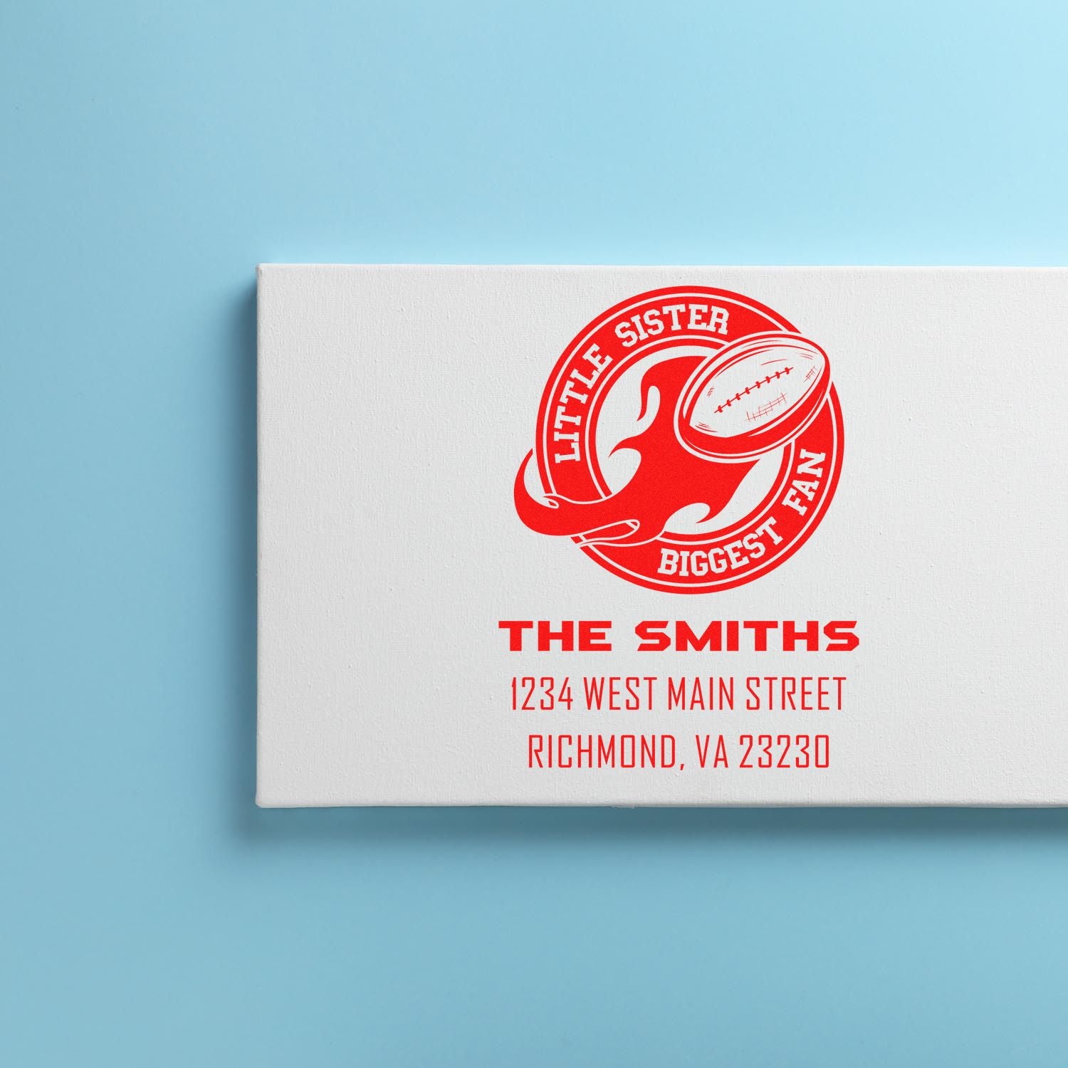 Custom rubber stamp design with football-themed Little Sister Biggest Fan logo and personalized family name and address.
