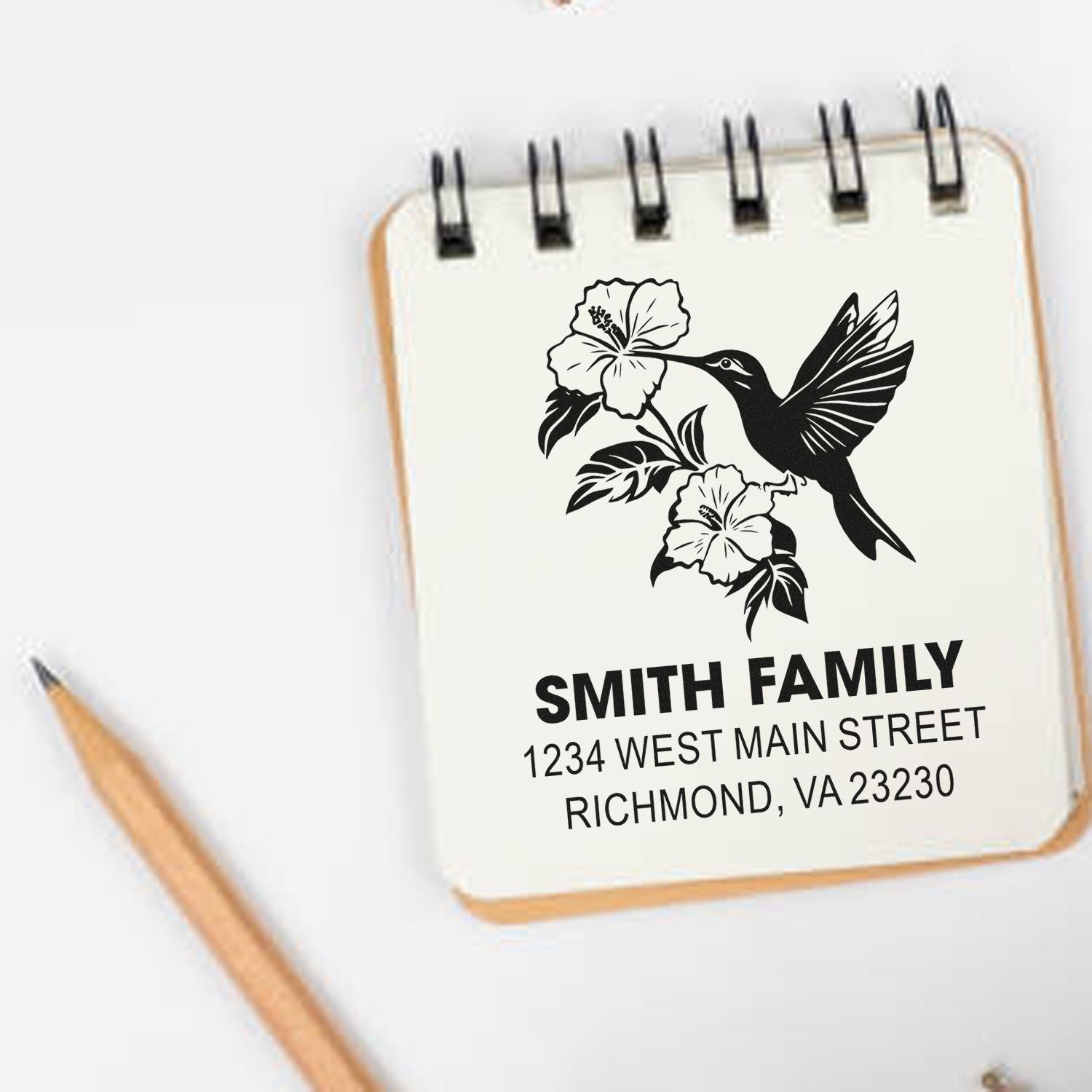 Custom family address rubber stamp with hummingbird and floral design, perfect for personalized envelopes and stationery.