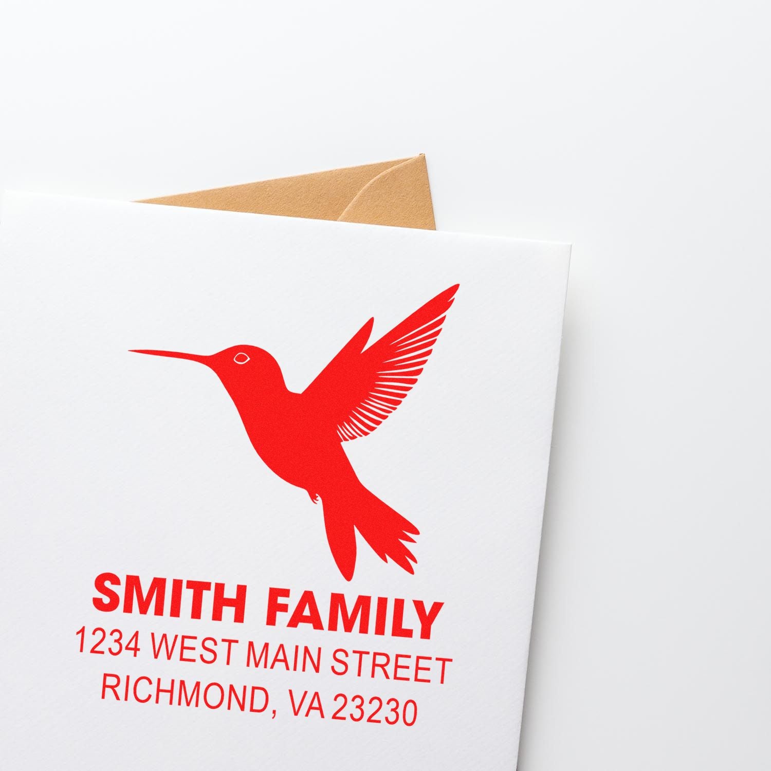 Personalized hummingbird return address rubber stamp for Smith Family with custom name and address in bold red ink.