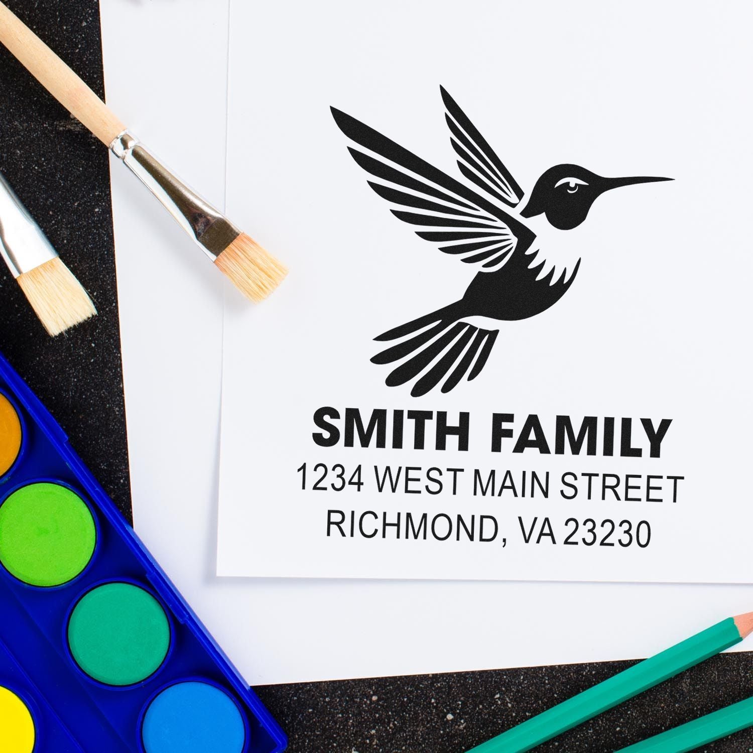 Custom rubber stamp with hummingbird design and Smith Family address for personalized stationery and return mail.