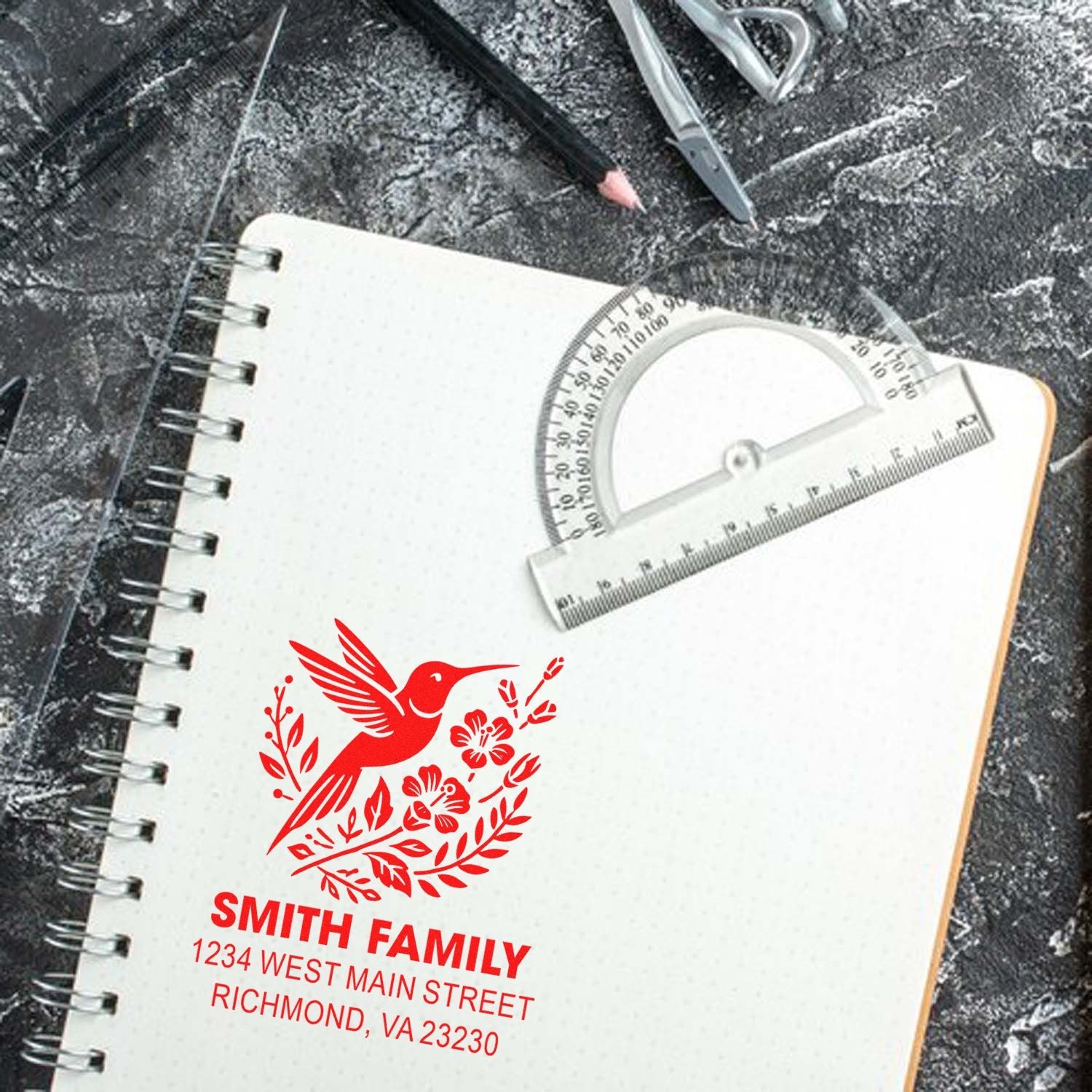 Custom hummingbird return address rubber stamp for Smith Family, displayed on a notebook with Richmond, VA address.