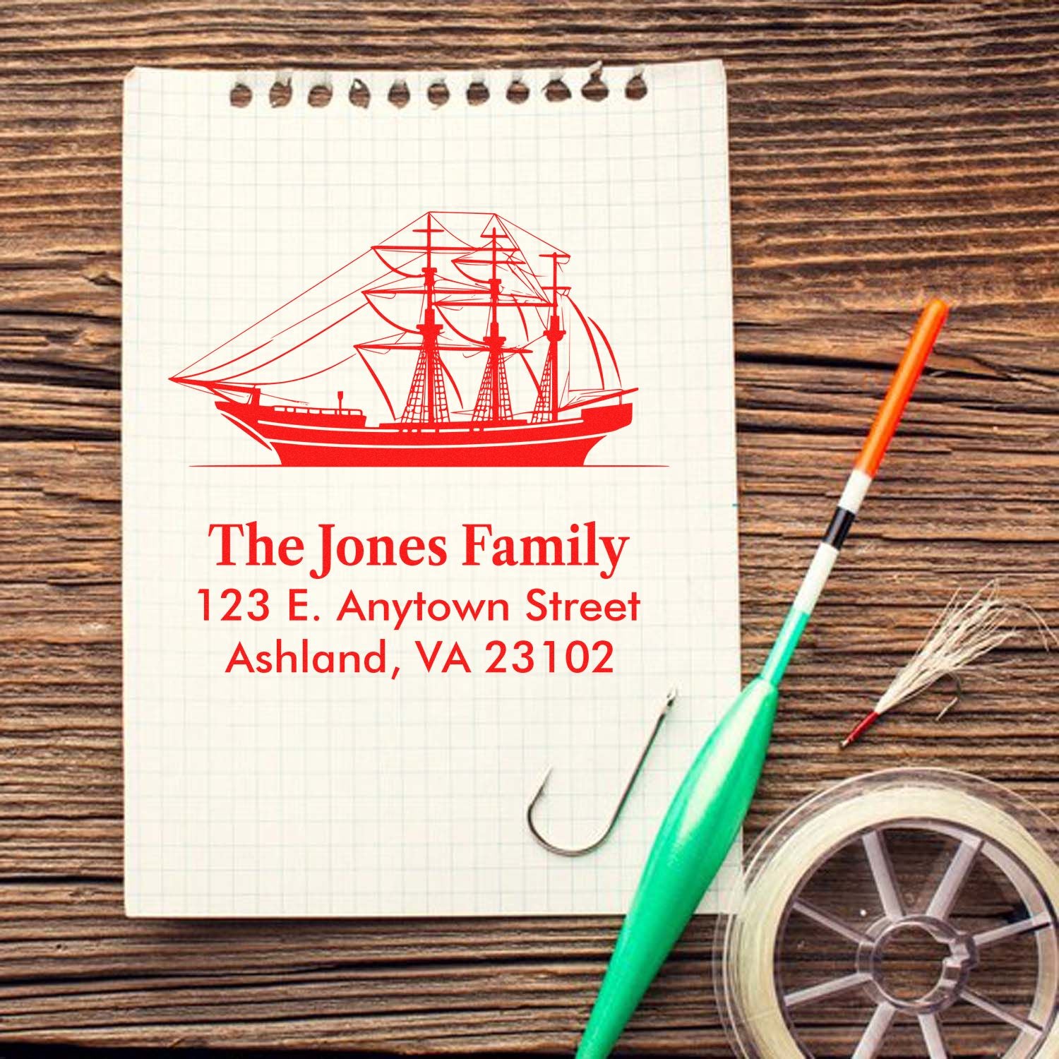 Custom sailboat return address rubber stamp with family name and Ashland, VA address on paper.