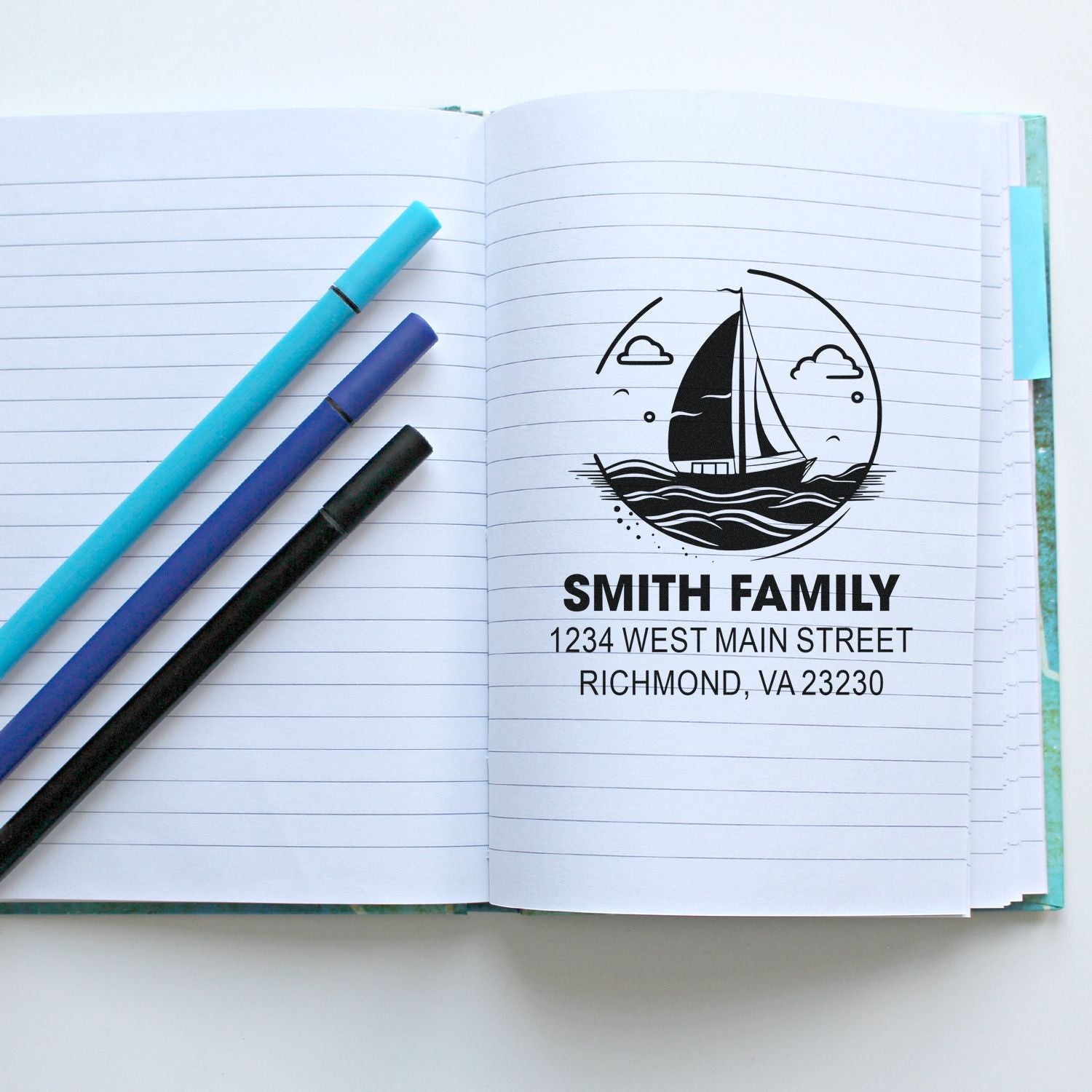 Custom return address rubber stamp with sailboat design, Smith Family name, and Richmond, VA address in a lined notebook.