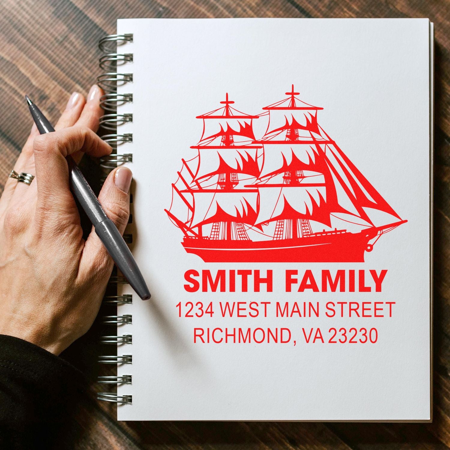 Personalized ship-themed return address rubber stamp for Smith Family, shown on a notebook page.