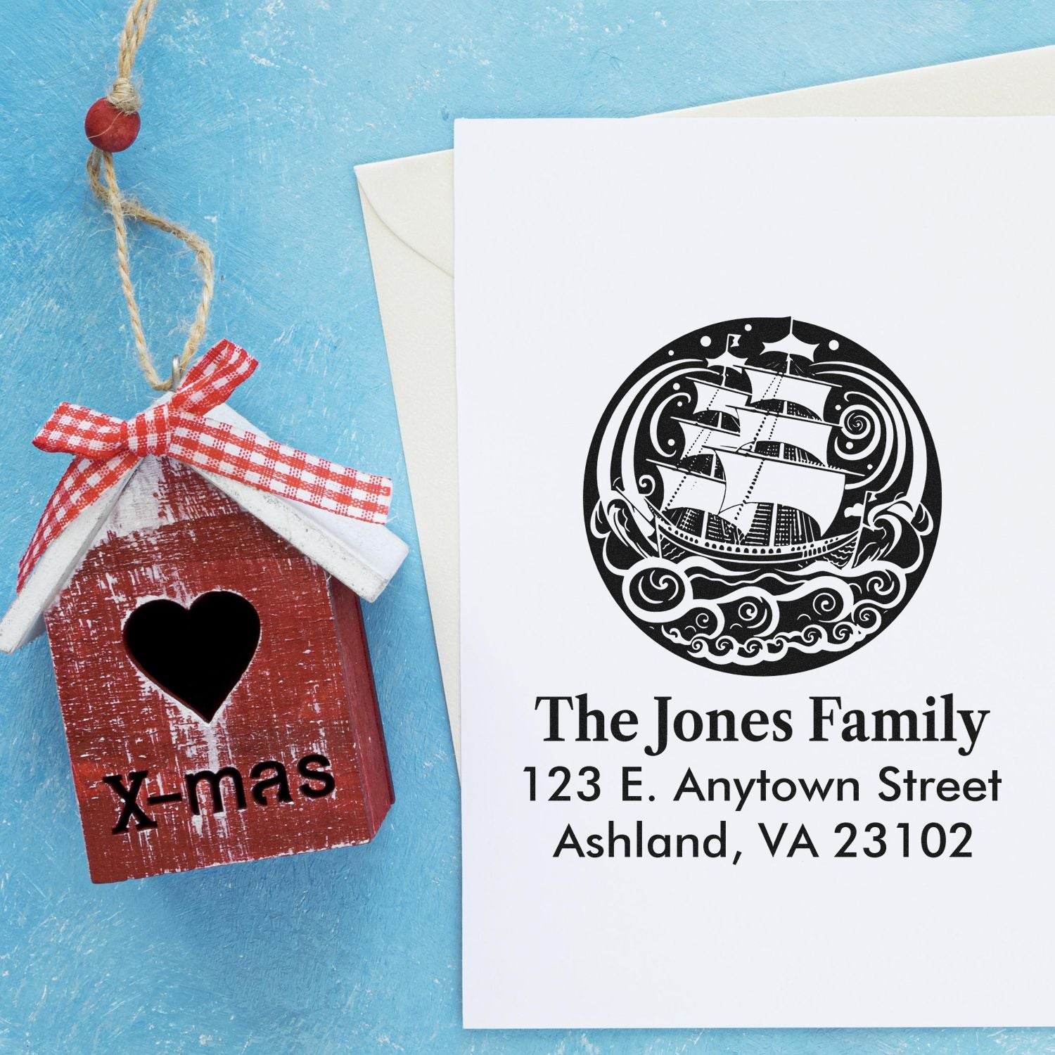 Custom return address rubber stamp with sailing ship logo and family name for holiday cards and stationery