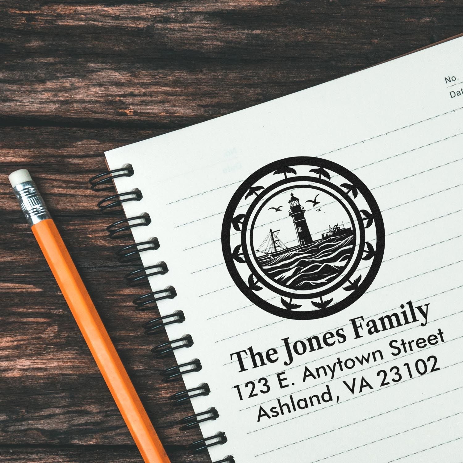 Personalized return address rubber stamp featuring a lighthouse family design on a notebook, ideal for custom stationery.