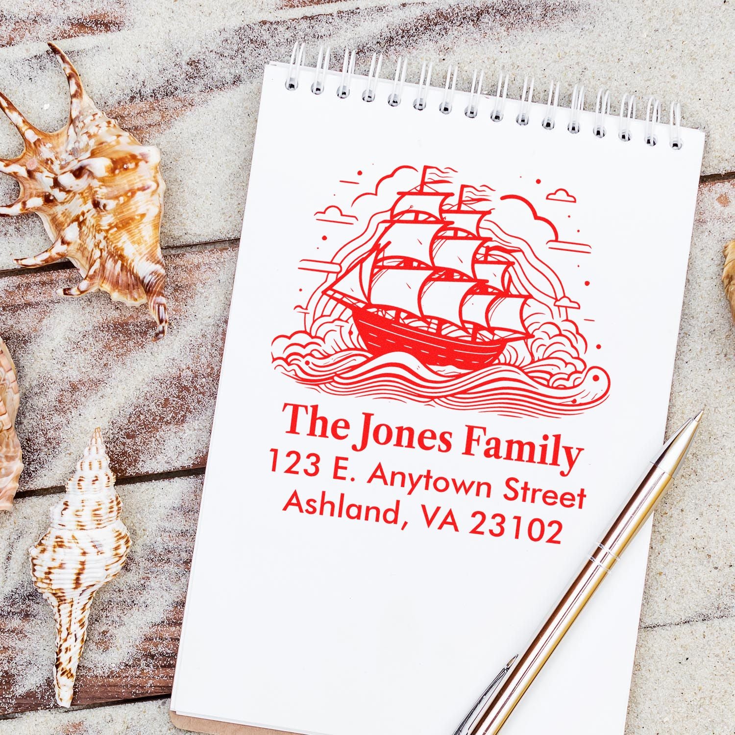 Custom return address rubber stamp with sailboat design, red ink on notebook for personalized nautical stationery.