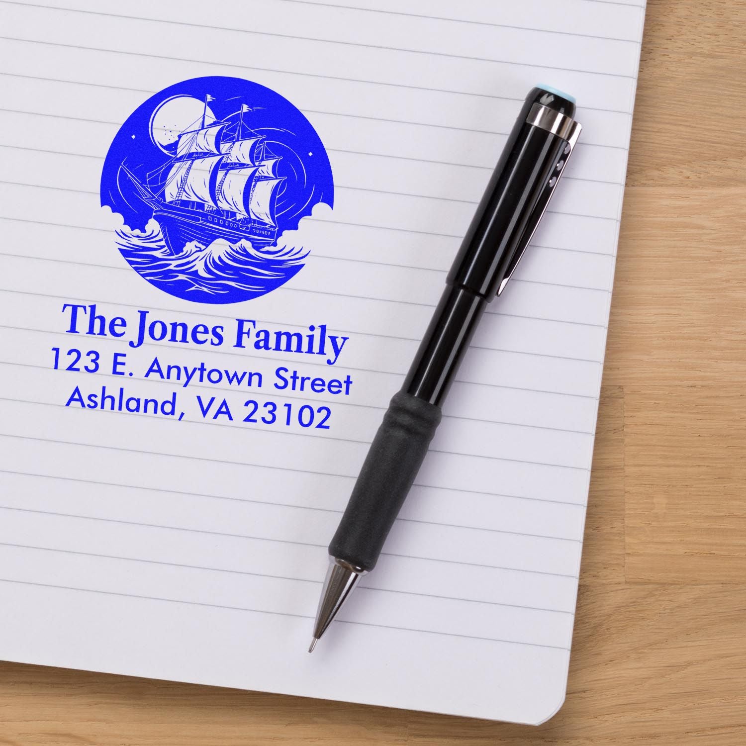 Personalized nautical rubber stamp with ship design, The Jones Family name, and address printed in blue on paper.