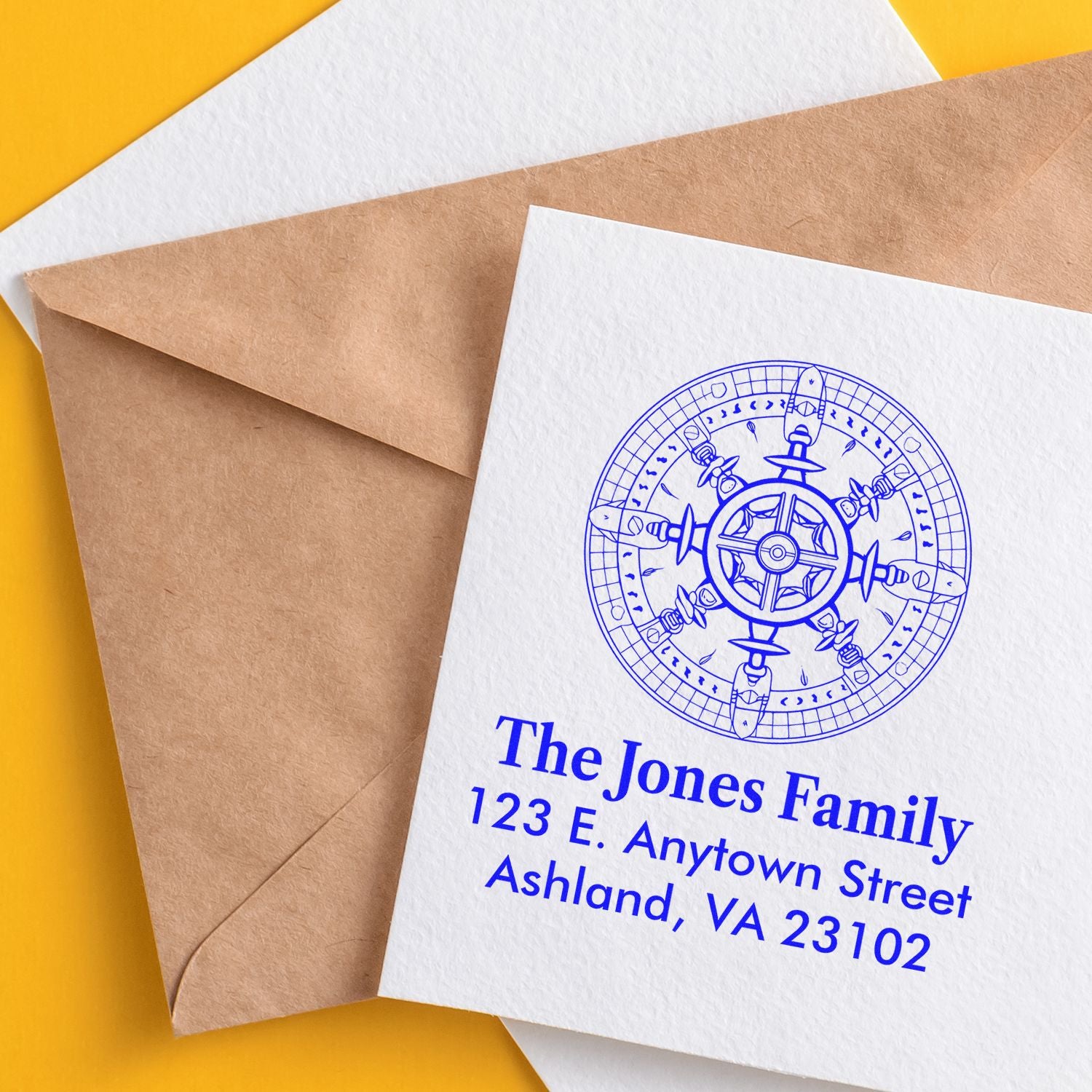 Personalized custom rubber stamp return address on envelope, blue ink family name, address, and nautical compass design.