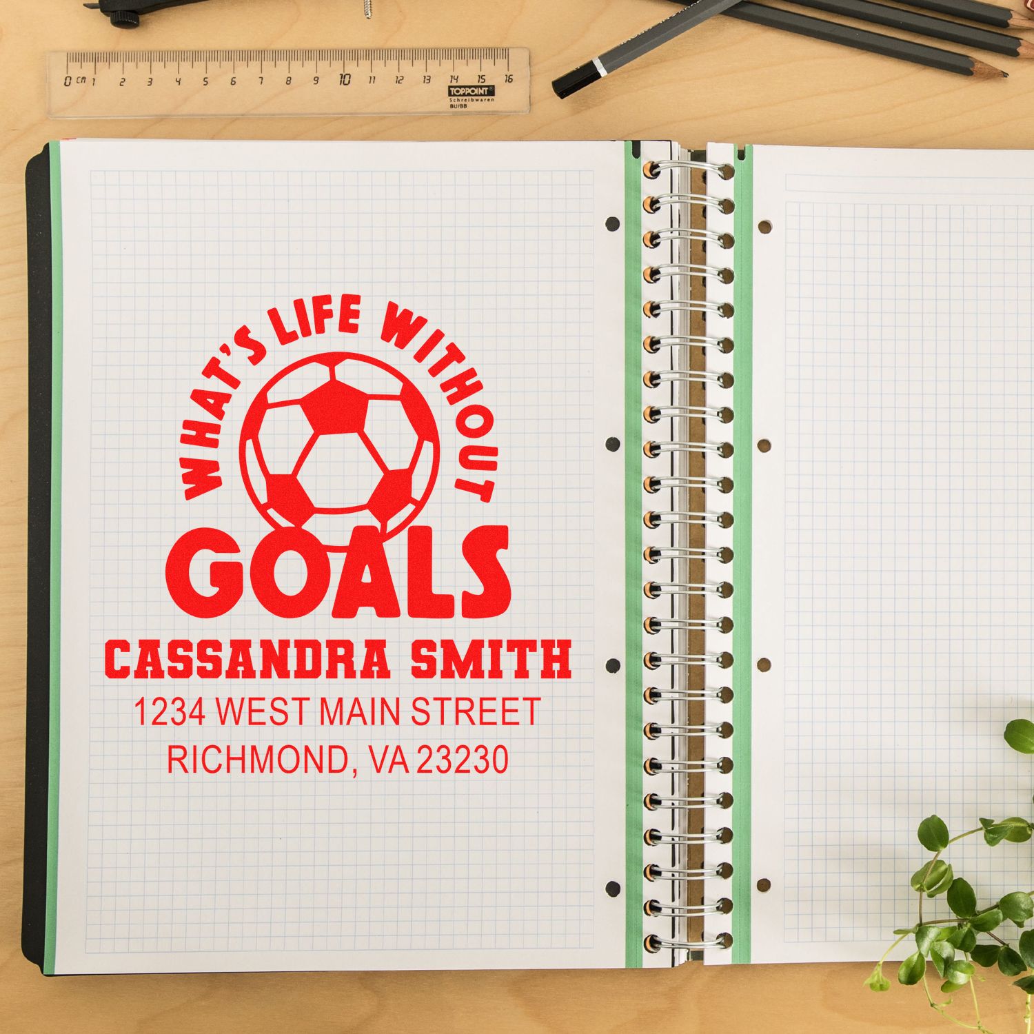 Custom address rubber stamp with soccer ball logo and Whats Life Without Goals on a notebook page.