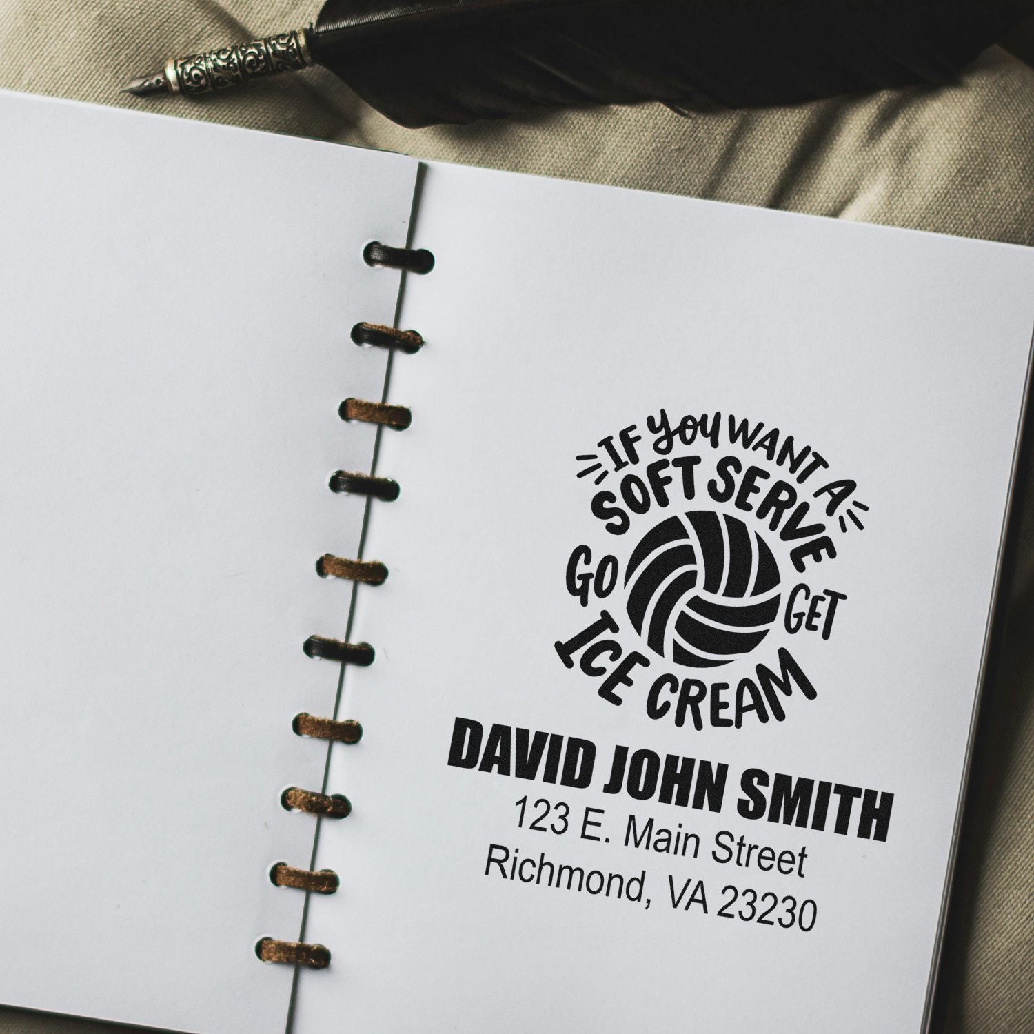 Custom rubber stamp with ice cream logo, business name, and address for branding notebooks or packaging.