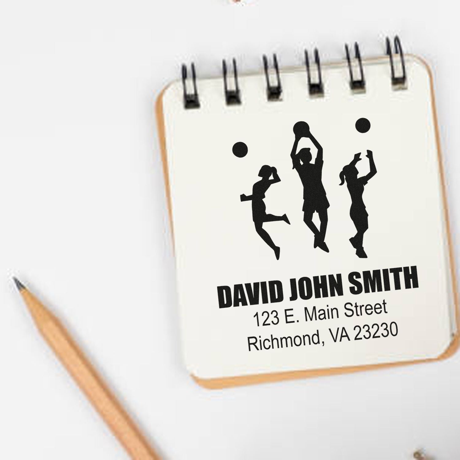 Custom volleyball return address rubber stamp with personalized name and Richmond, VA address on notepad.