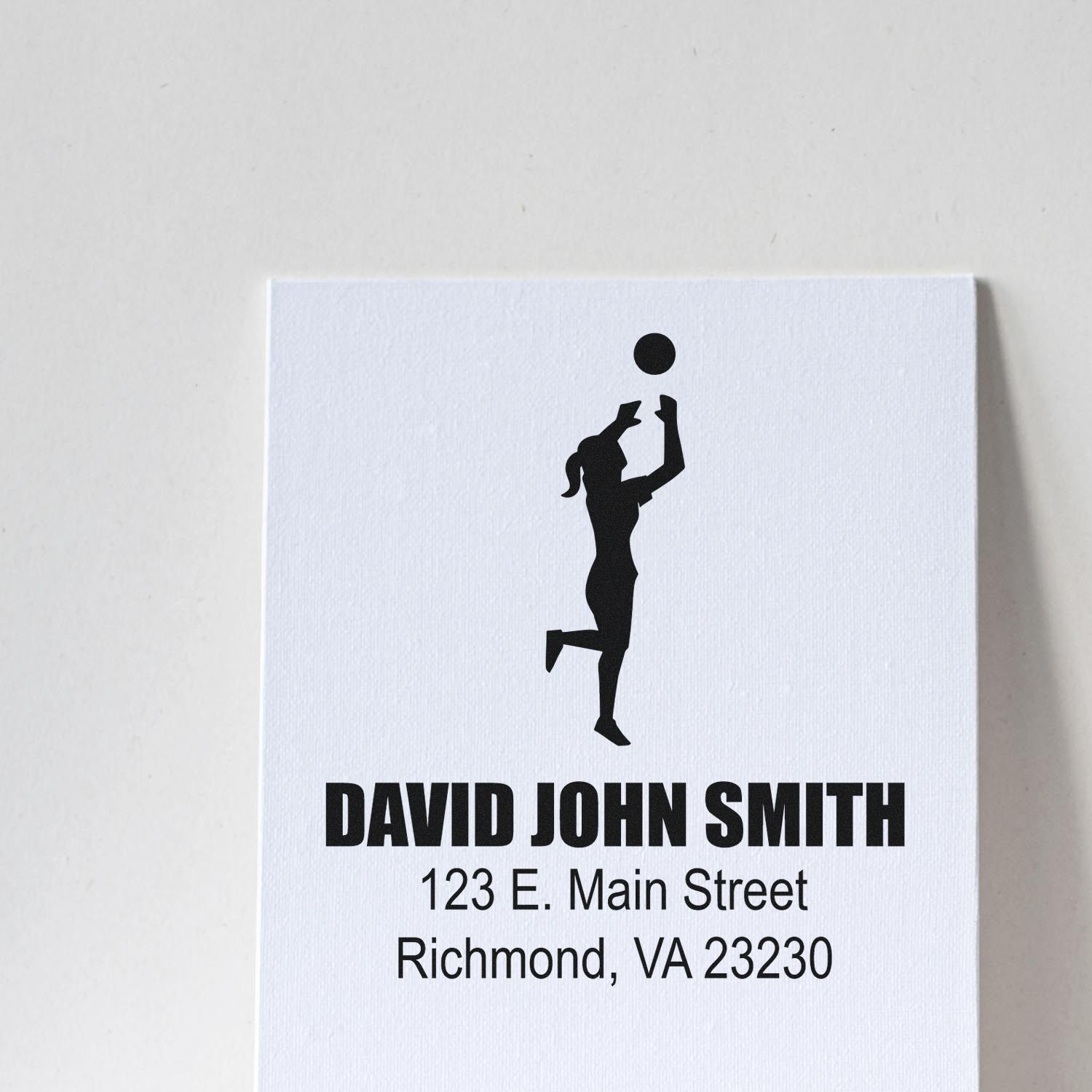 Custom rubber stamp with volleyball player silhouette and return address for David John Smith, Richmond, VA 23230.