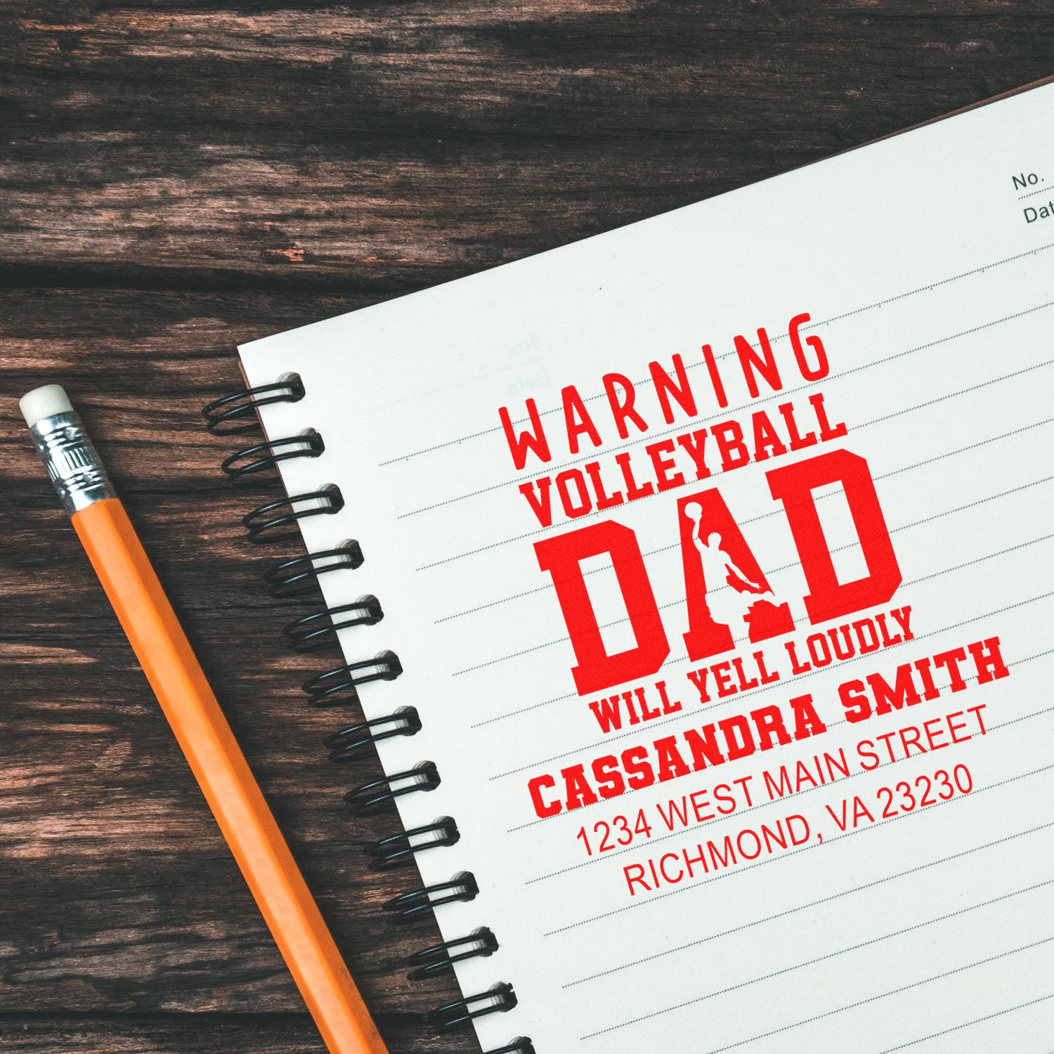 Custom volleyball dad rubber stamp design with warning text, name, and address on a notebook page.