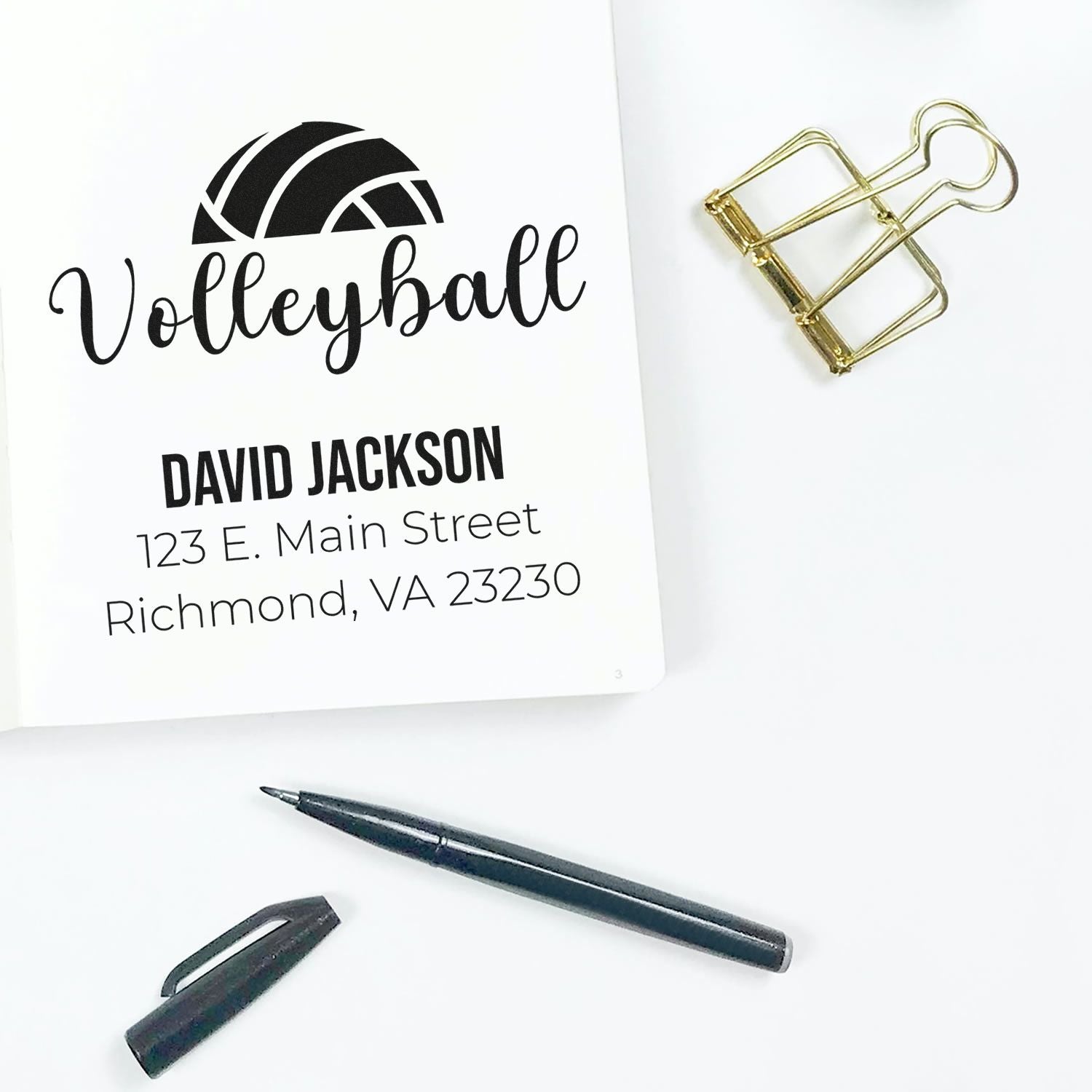 Custom volleyball rubber stamp with logo, name, and return address on stationery mockup.
