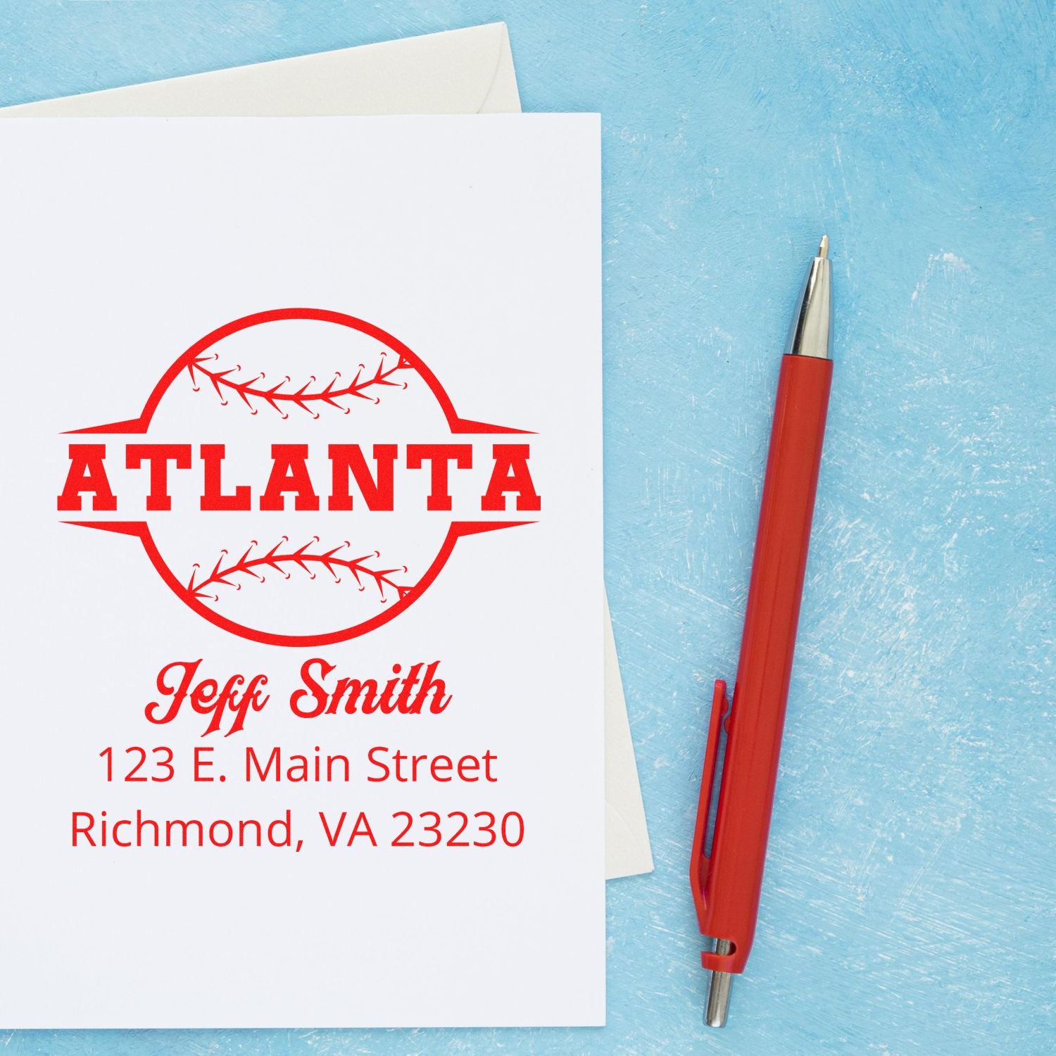 Custom Atlanta baseball rubber stamp with personalized name and address, shown on stationery beside a red pen.