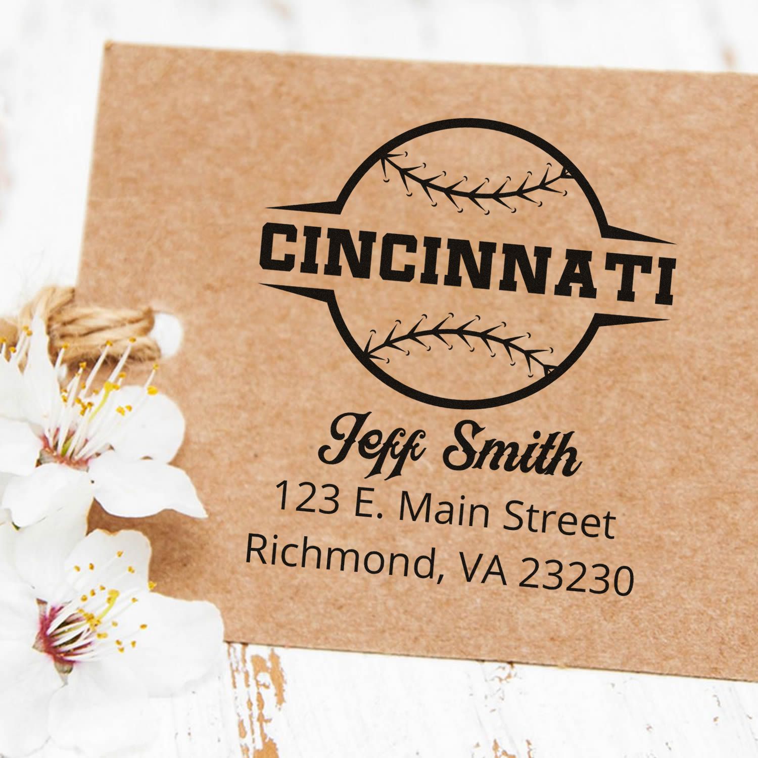 Custom Cincinnati rubber stamp with baseball-style logo, name, and return address for business packaging and branding.