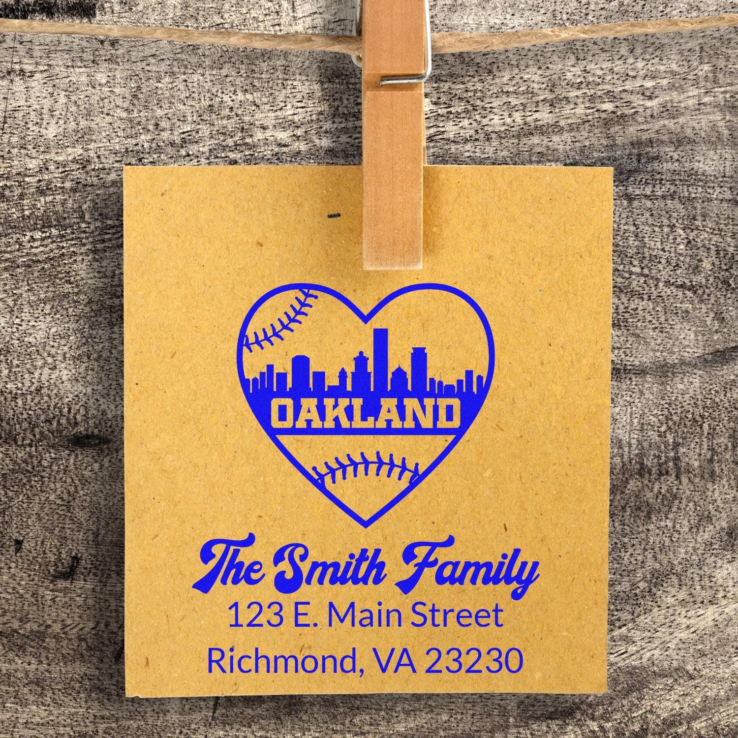 Custom rubber stamp sample with Oakland heart skyline, baseball accents, and Smith family address for personalized mail.