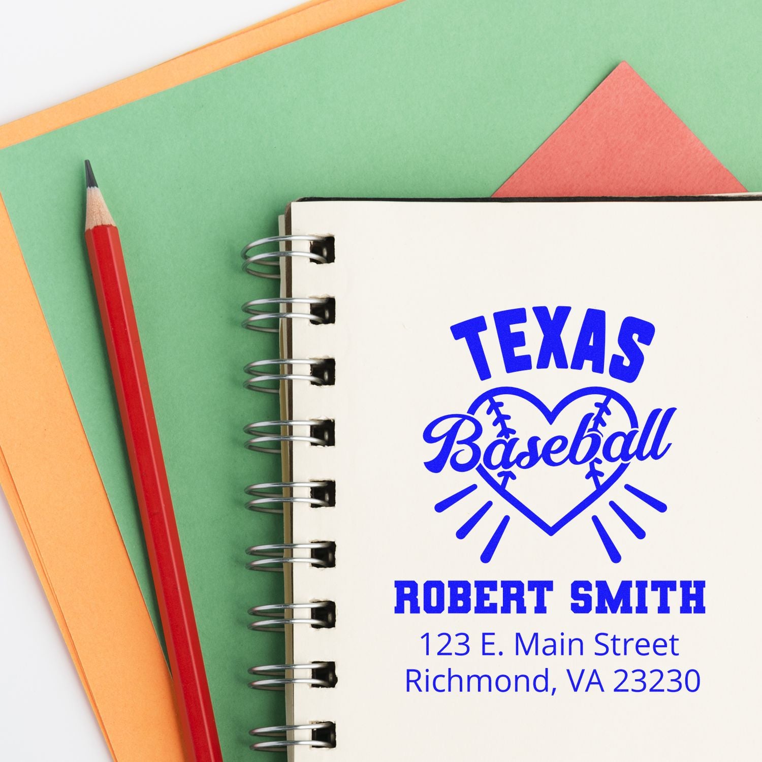 Custom Texas Baseball rubber stamp with name and address imprint on a notebook, shown with pencil and colorful paper.