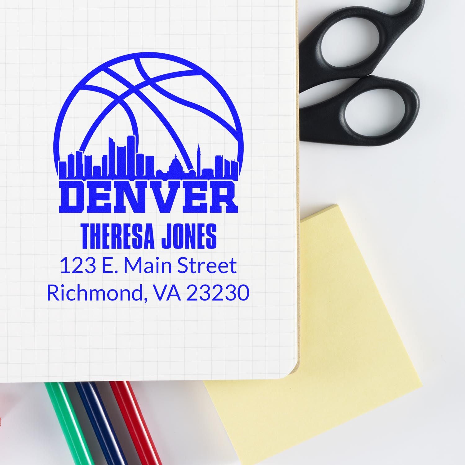Custom Denver rubber stamp design with Theresa Jones return address and skyline logo on a notebook page