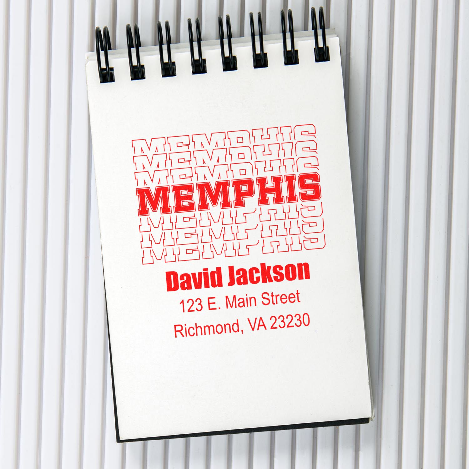 Custom rubber stamp imprint with Memphis logo, David Jackson name, and Richmond, VA address on notepad
