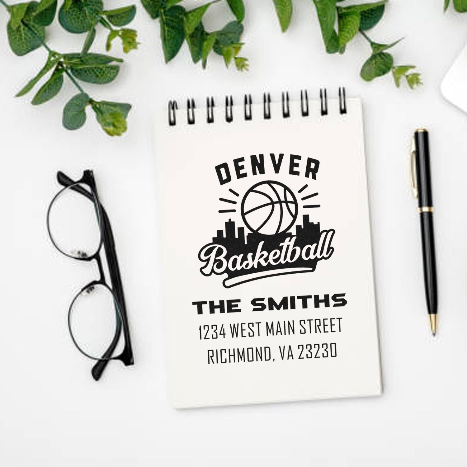 Custom Denver Basketball rubber stamp mockup with The Smiths name and address on a notebook for personalized family stationery.