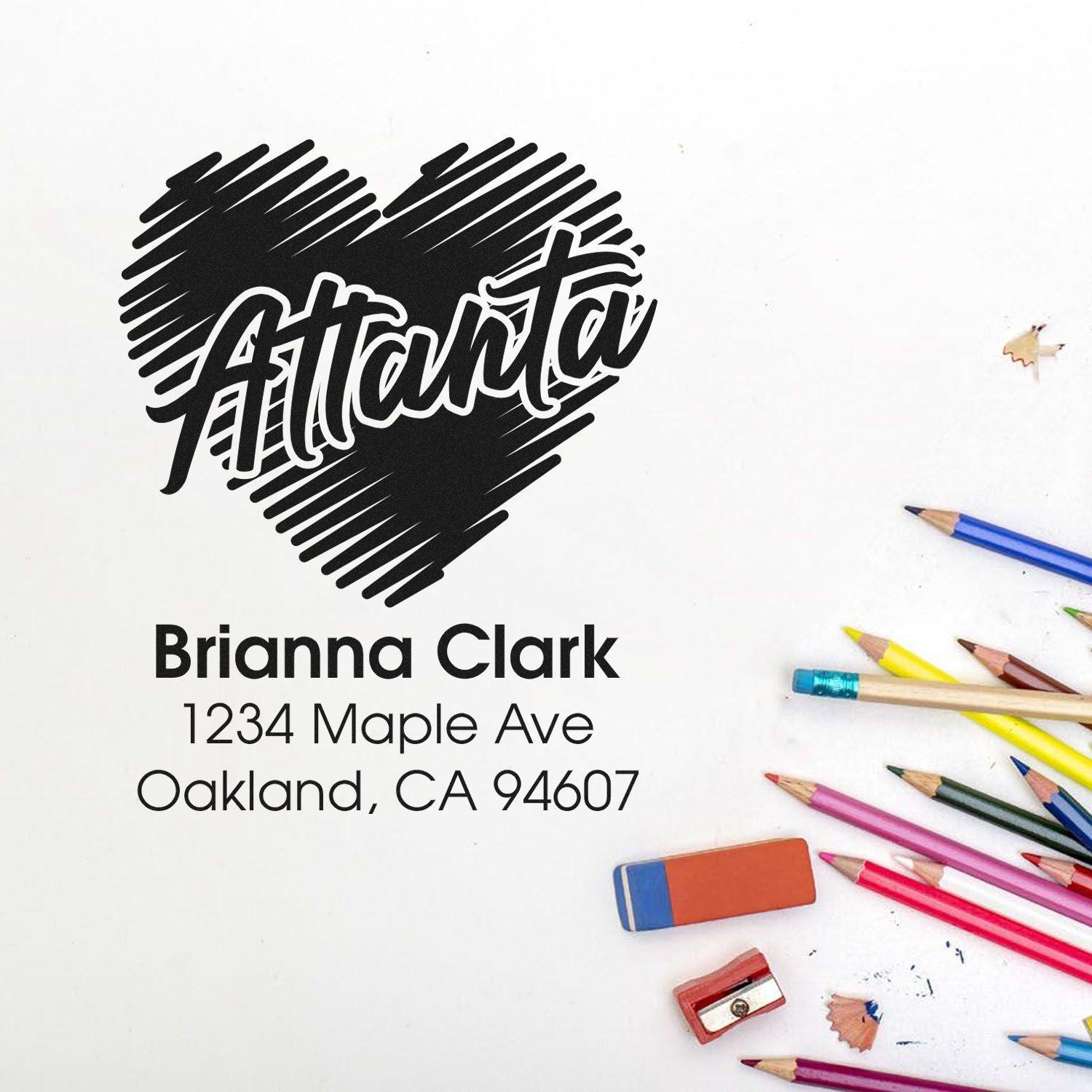 Custom rubber stamp with heart logo and personalized name and address for school supplies, stationery, or return mail.