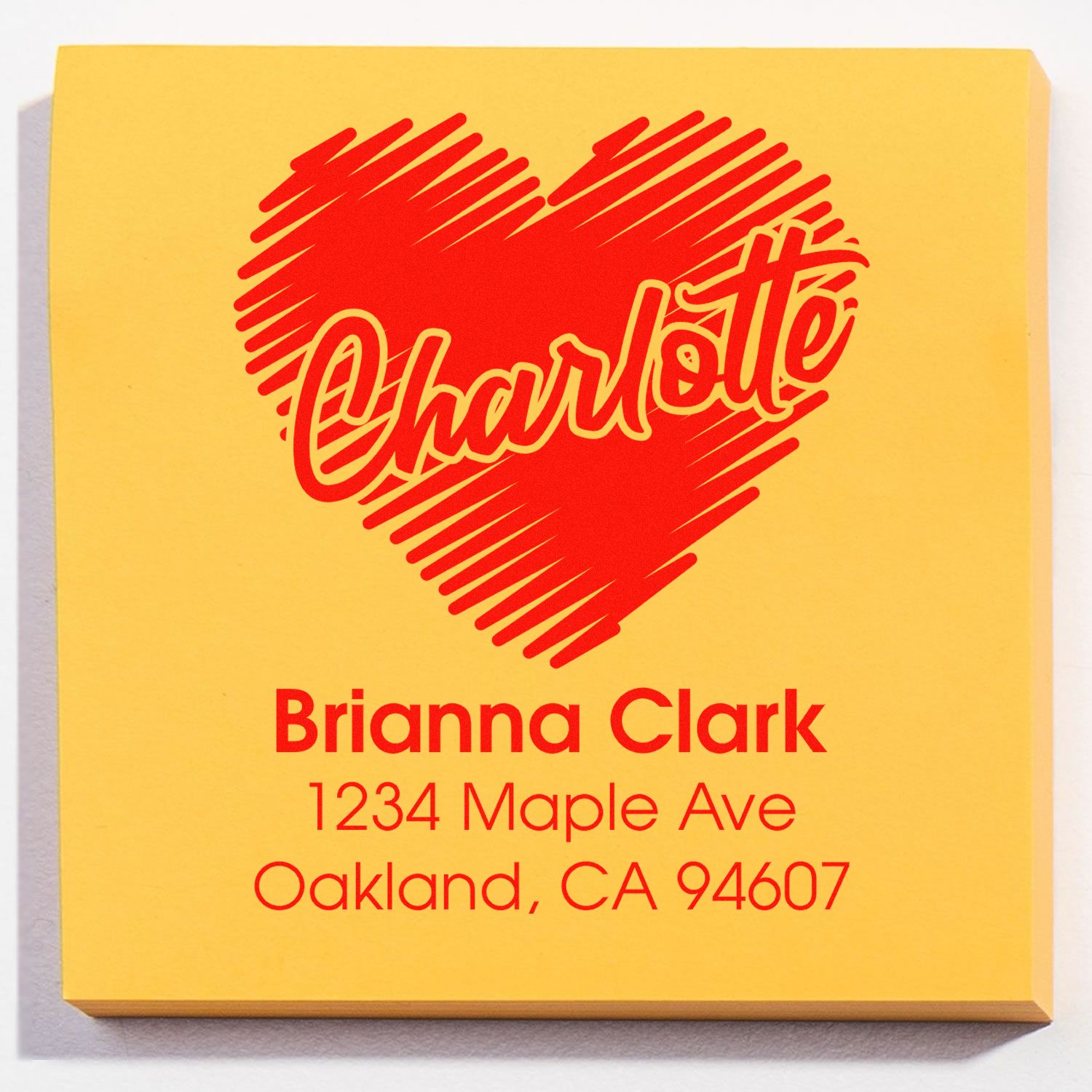 Custom return address rubber stamp with heart logo for Brianna Clark, Oakland, CA 94607.